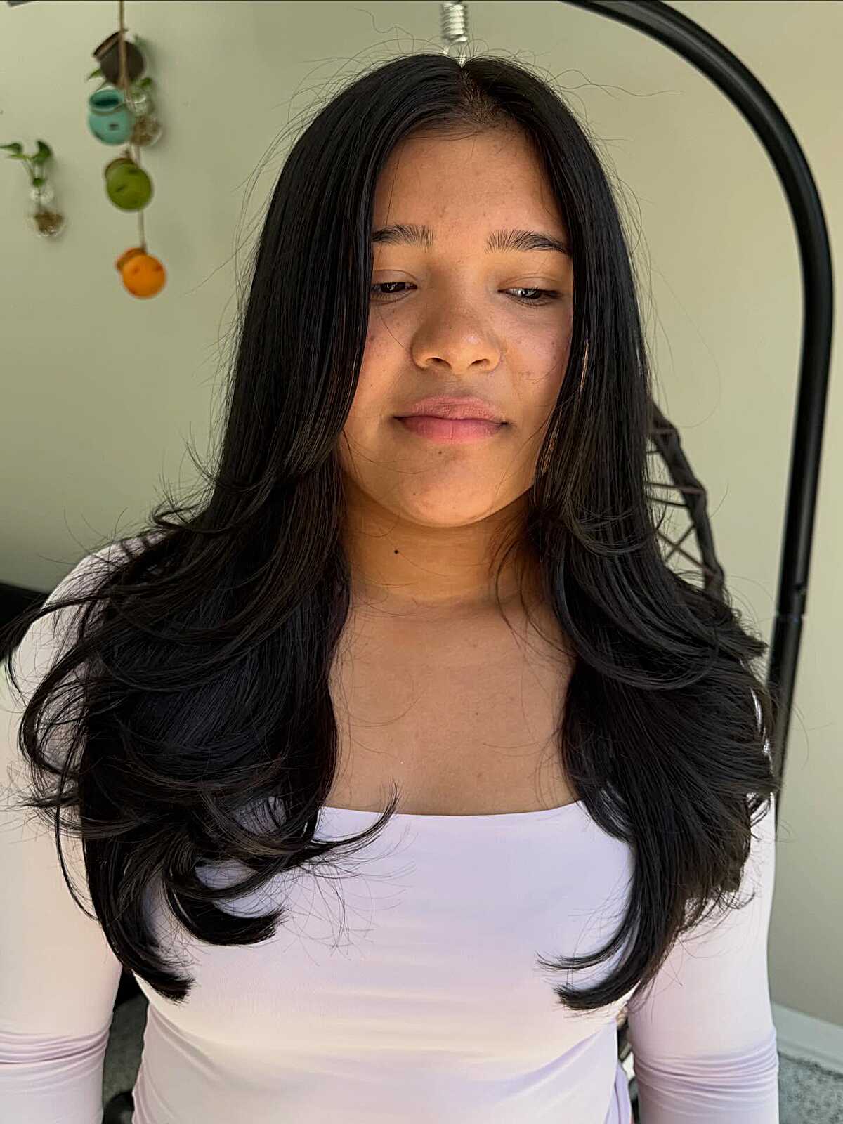 Long black hair with flipped out ends and face framing