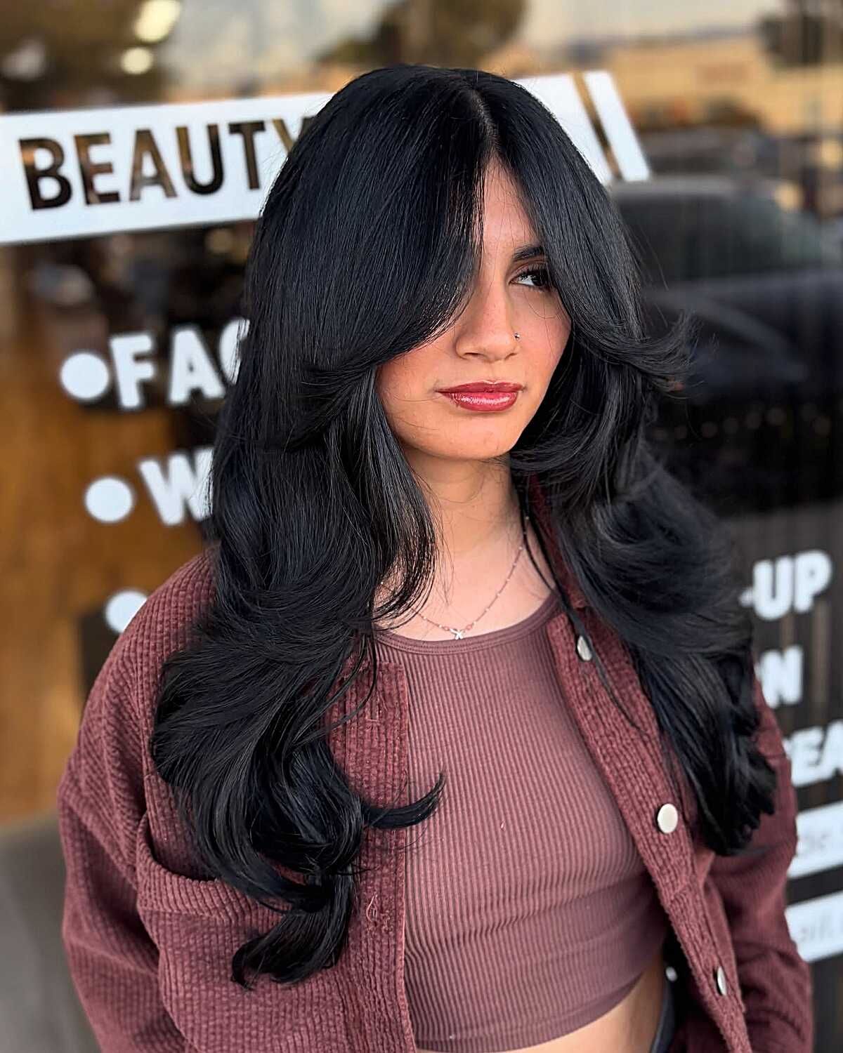 Full-bodied black hair with big curled curtain layers