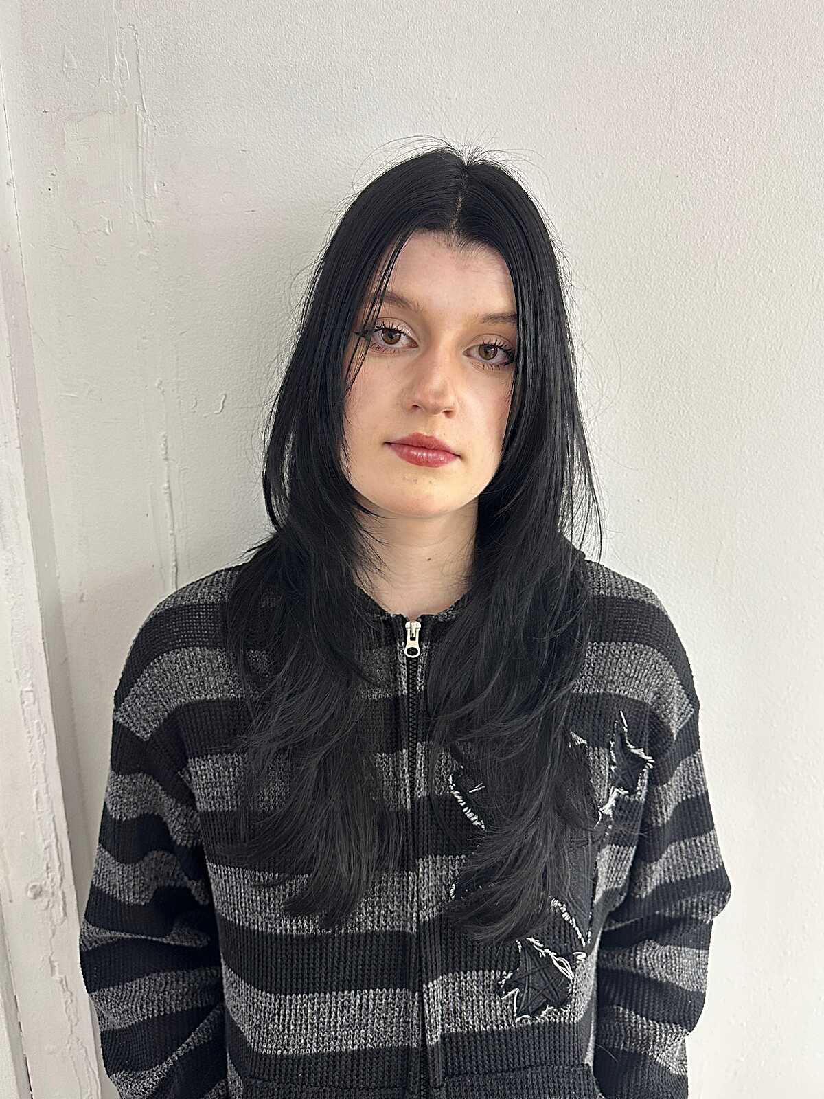 Long black hair with grunge-style curtain face framing layers