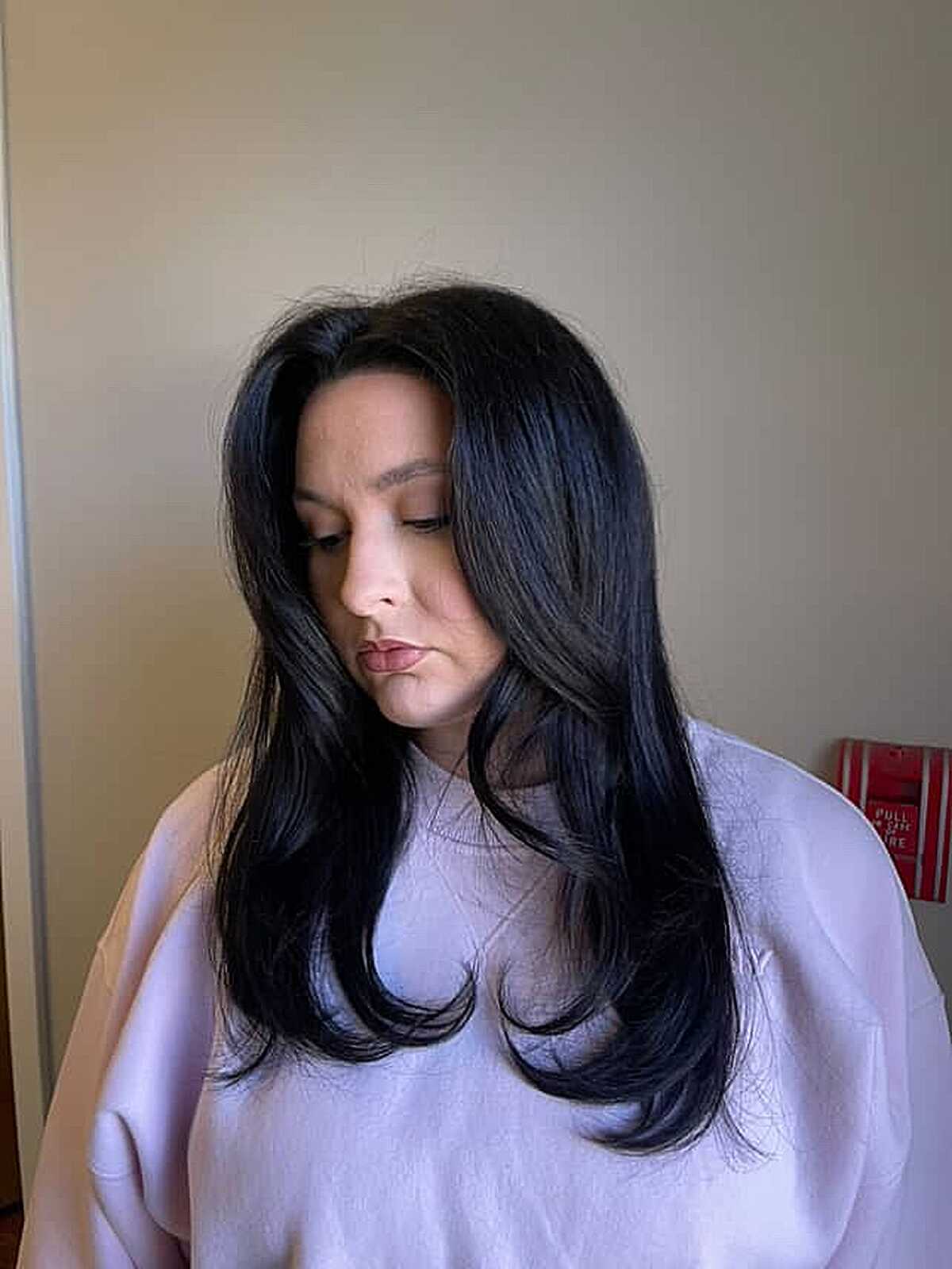 Black hair with soft swooping face framing layers