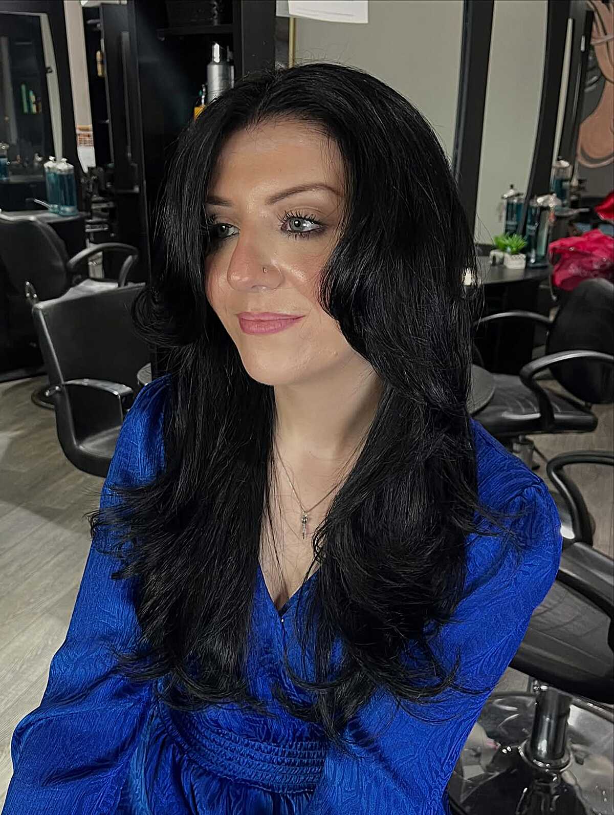 Black hair with tousled volume and curtain face layers
