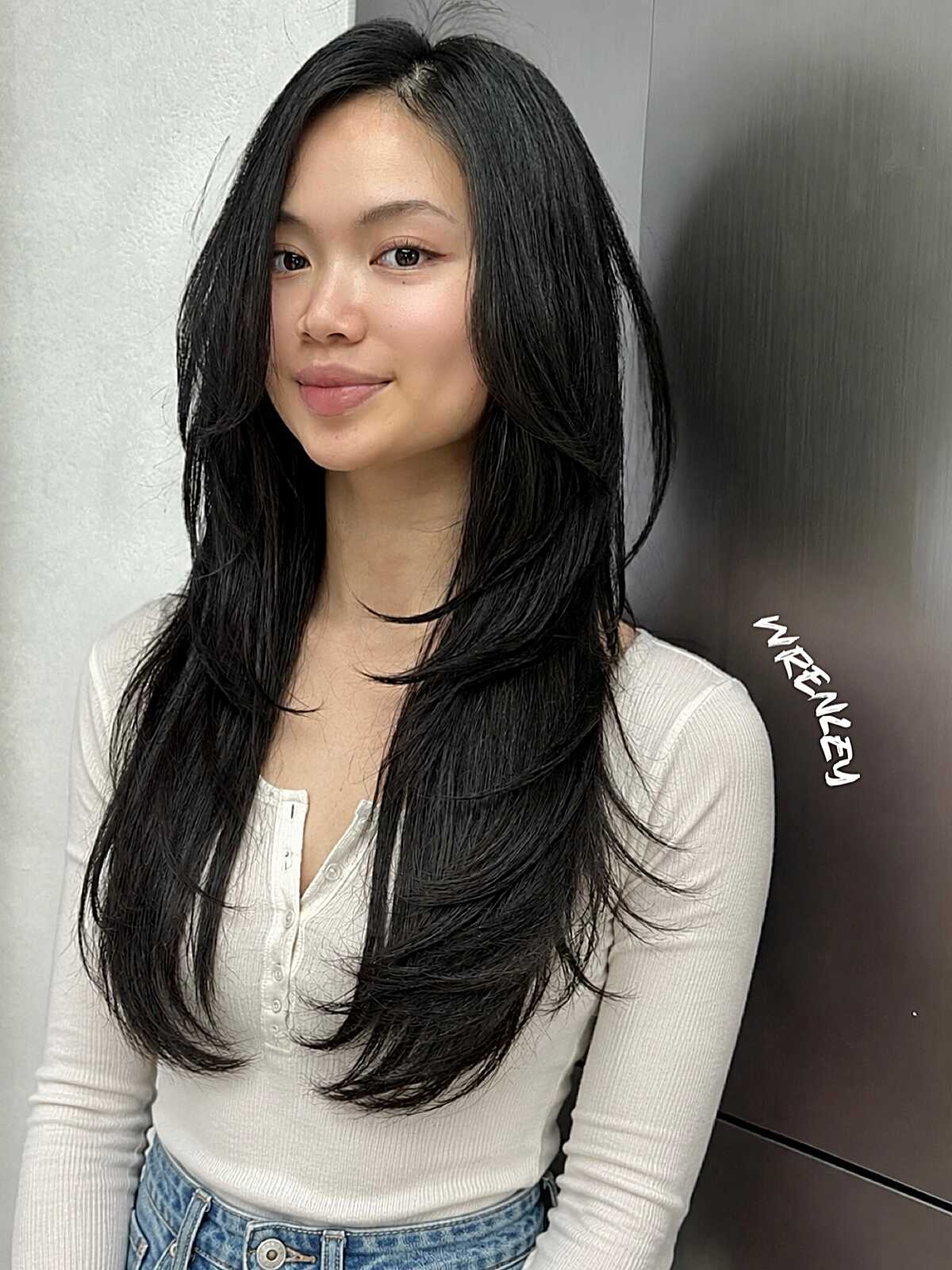 Long black hair with wispy face framing layers