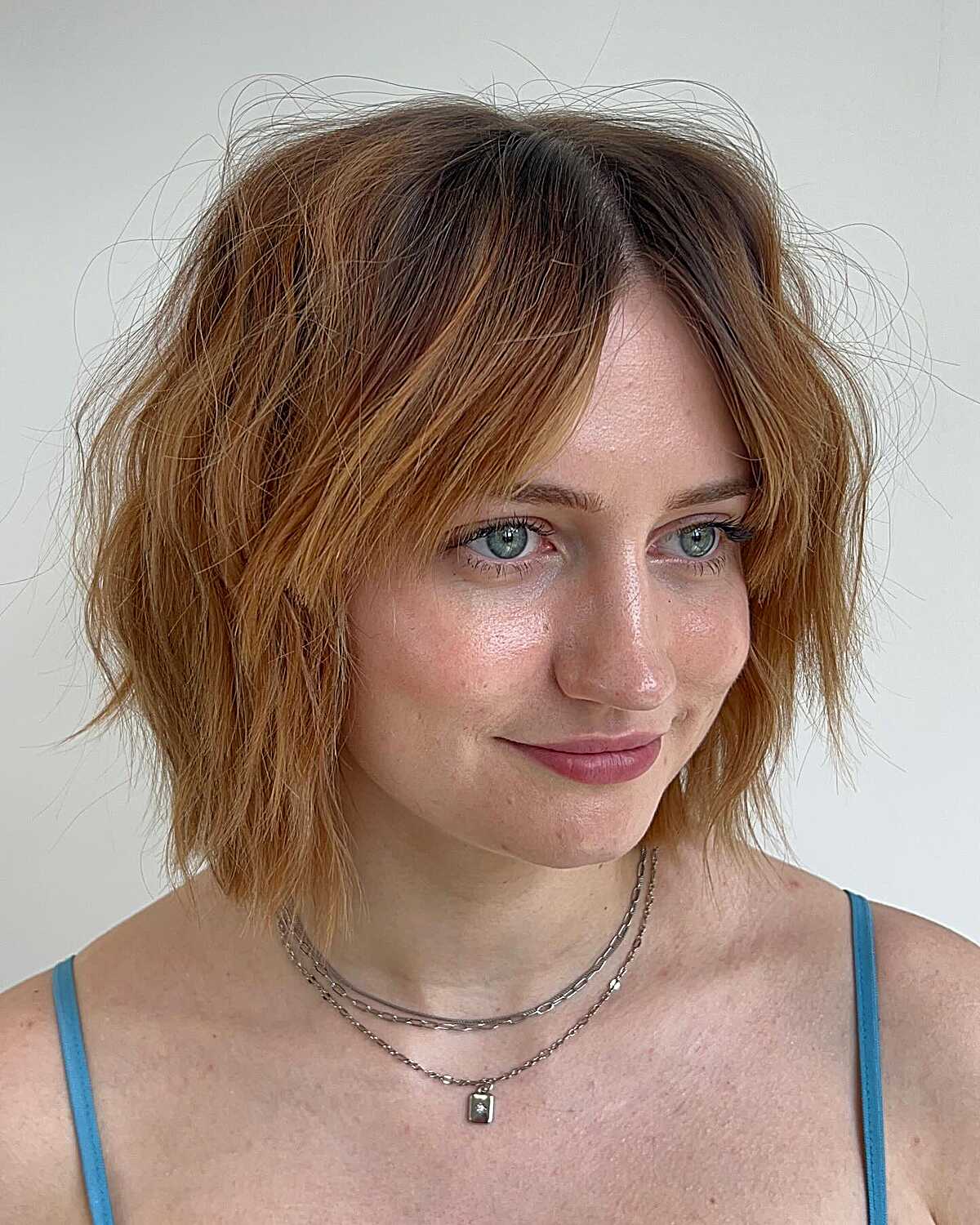 Shaggy copper ombre cowgirl bob with dark roots