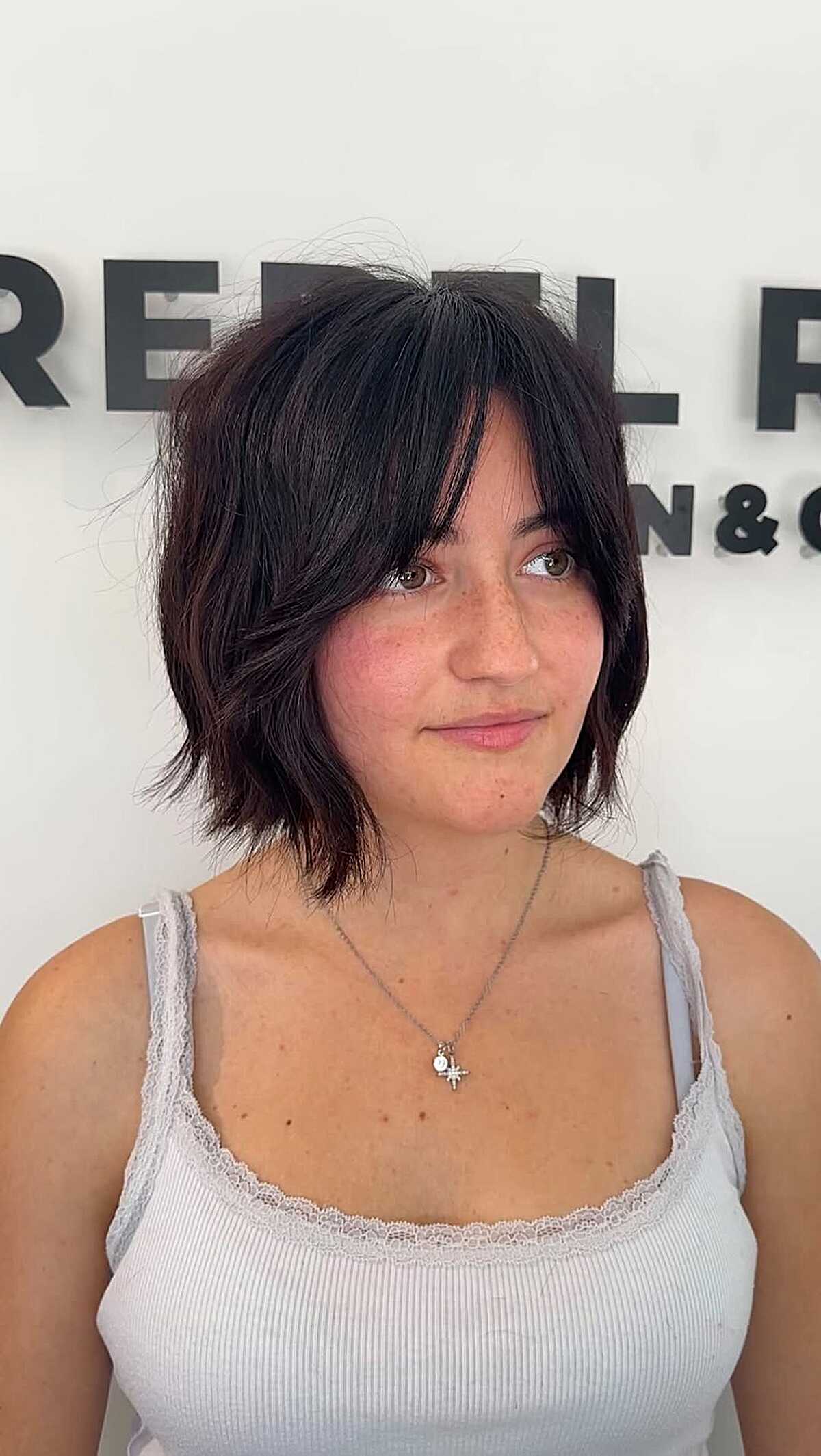 Dark choppy cowgirl bob with piece-y textured layers
