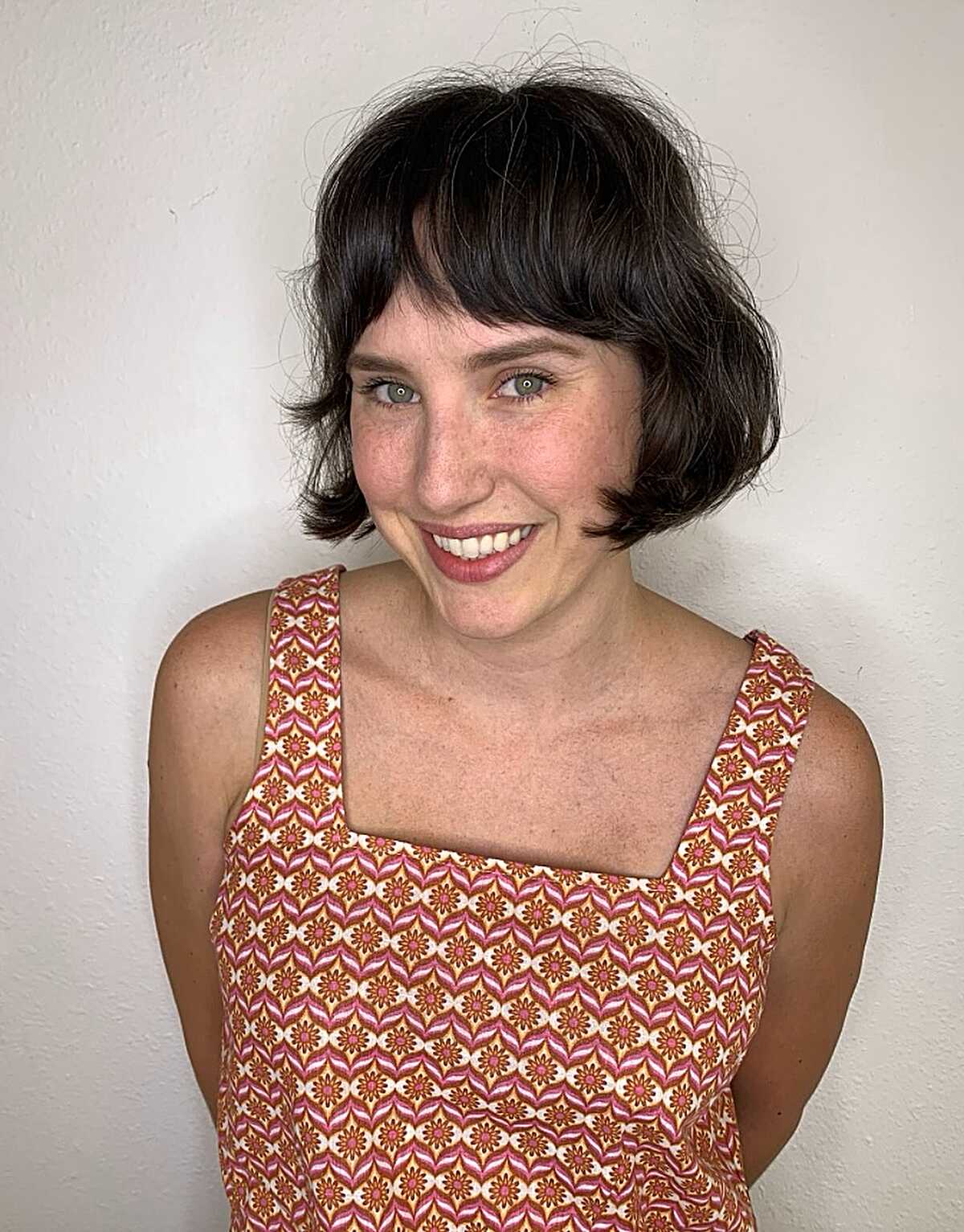 Short dark cowgirl bob with choppy baby bangs