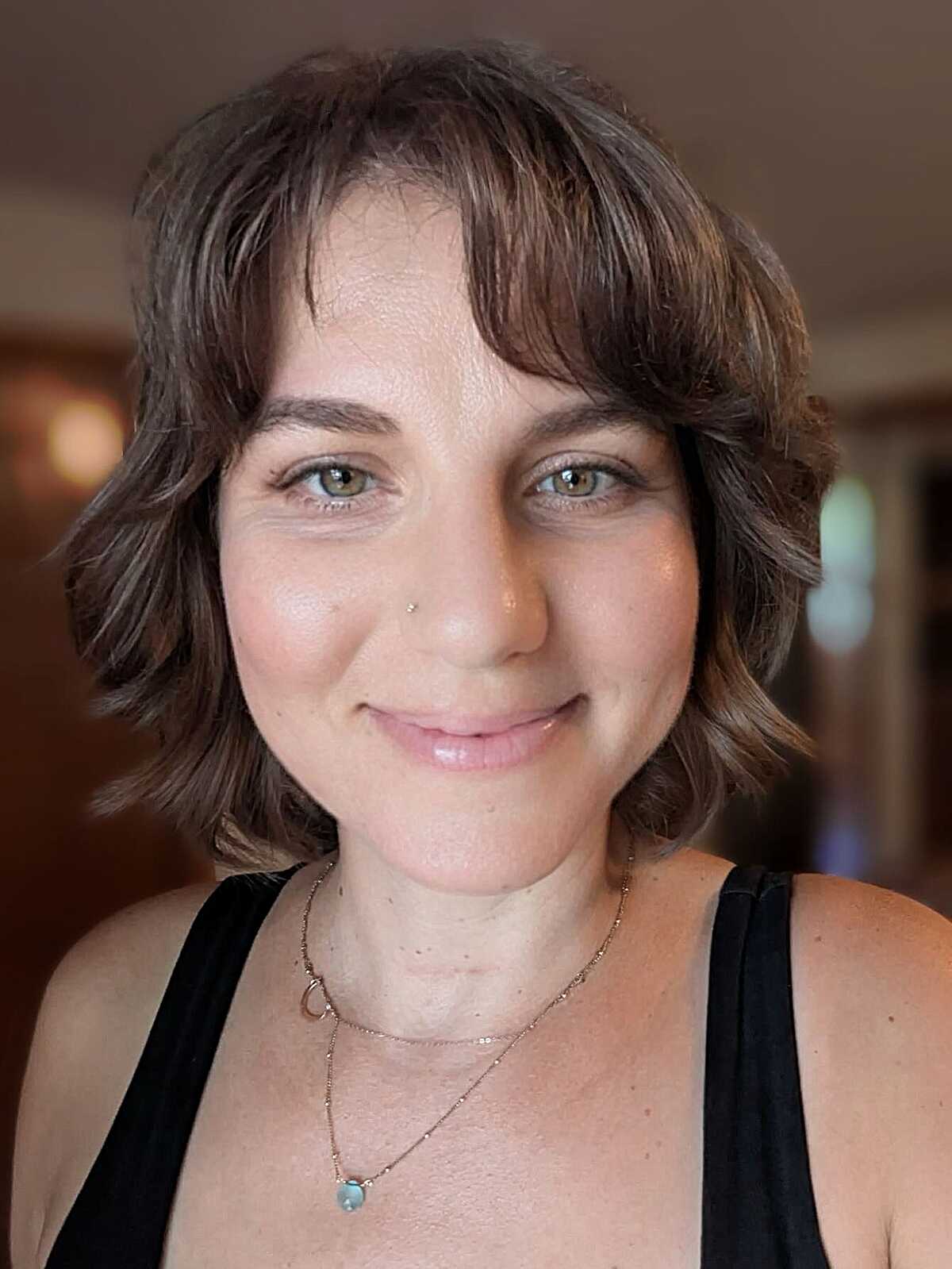 Soft wavy brunette cowgirl bob with wispy micro bangs