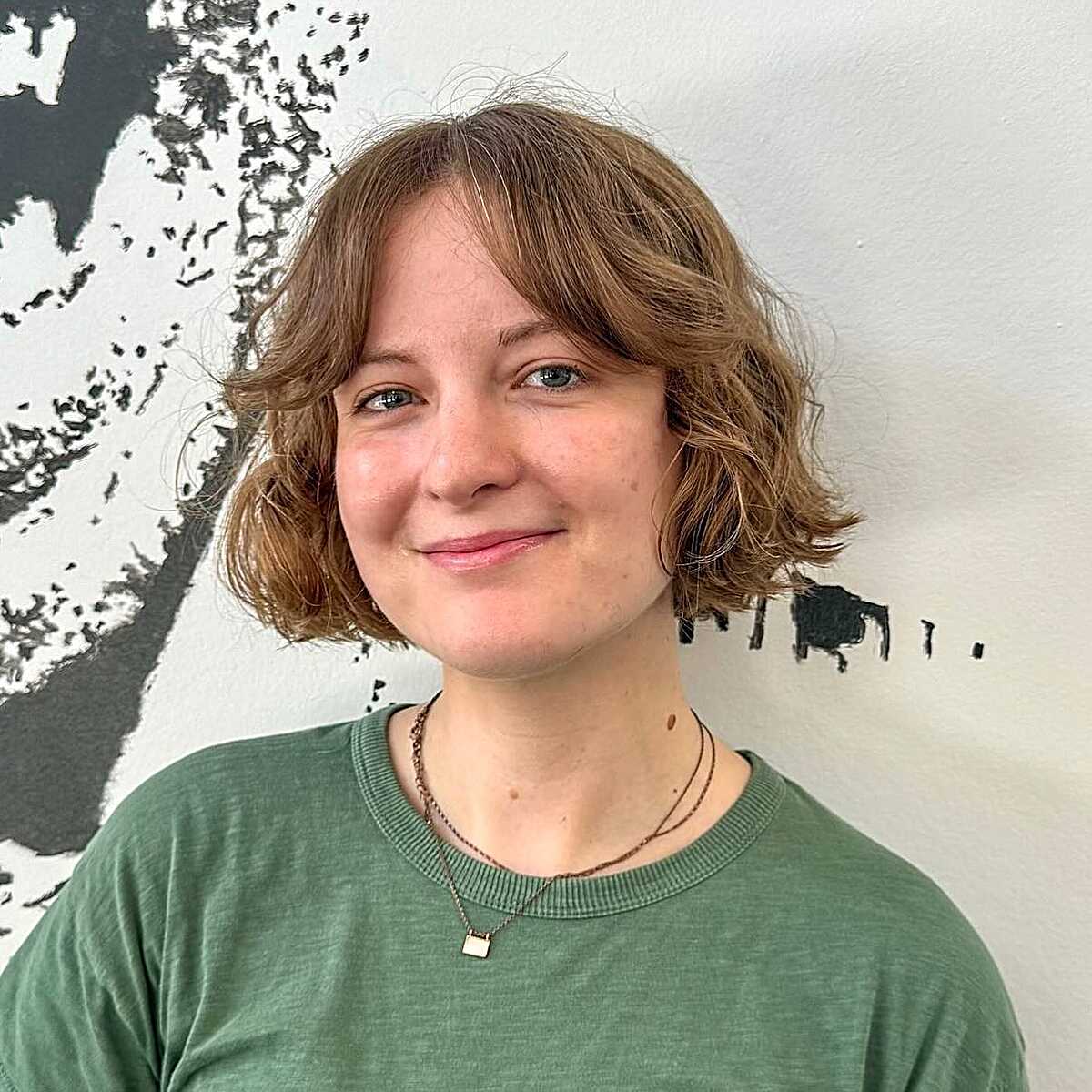 Strawberry blonde wavy cowgirl bob with grown-out bangs