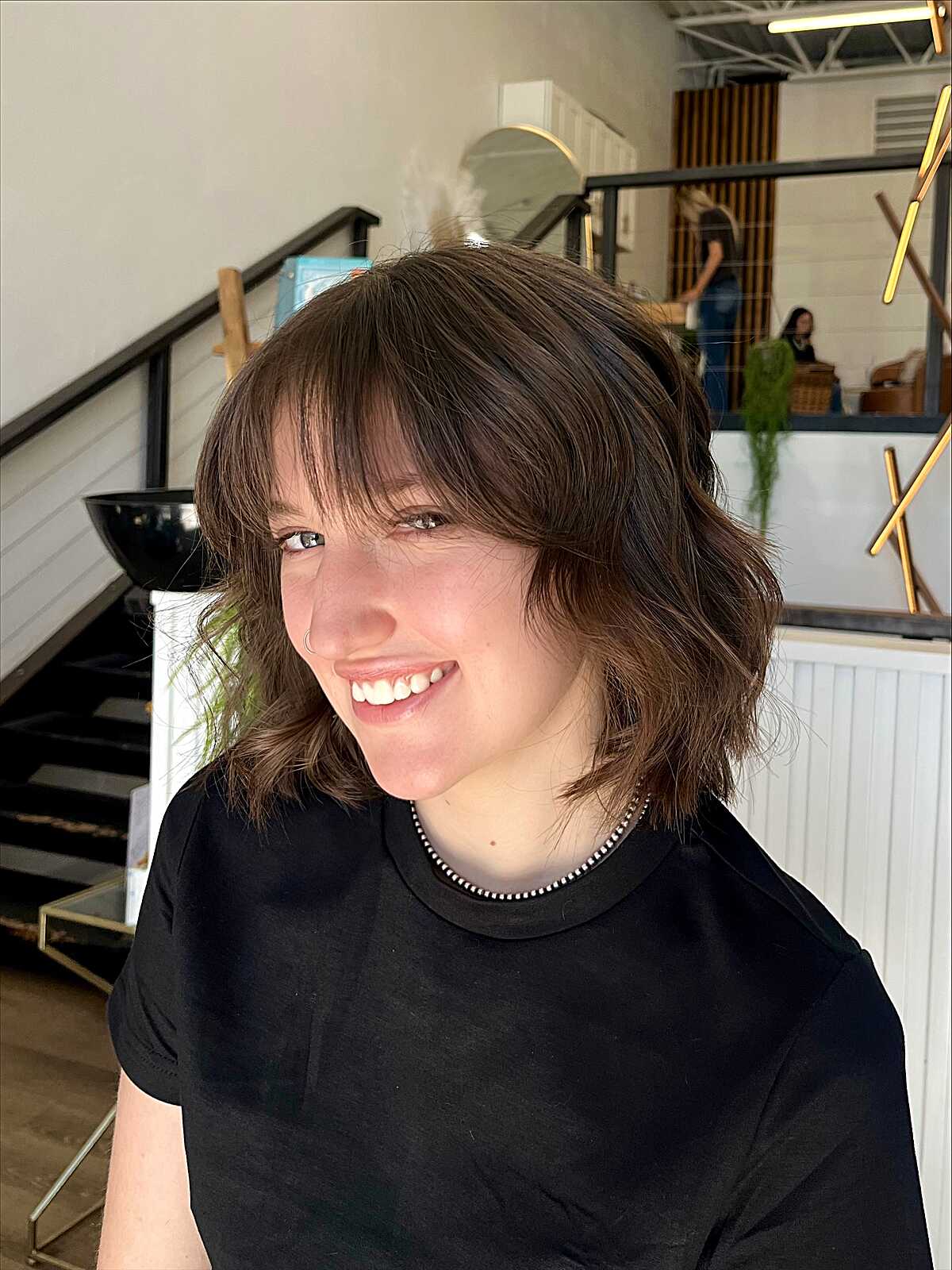 Tousled chocolate brown cowgirl bob with side-swept bangs