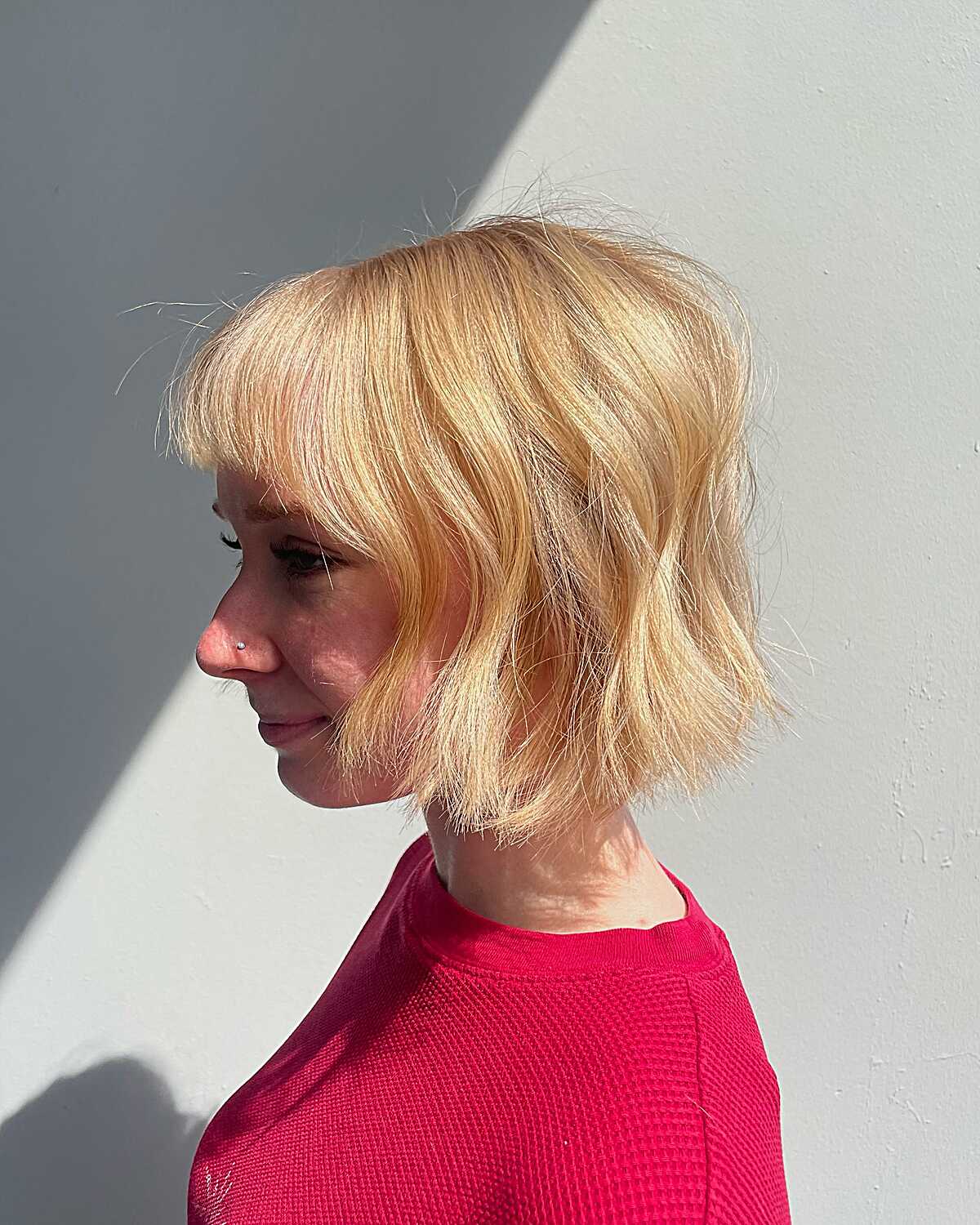 Side view of warm blonde wavy cowgirl bob