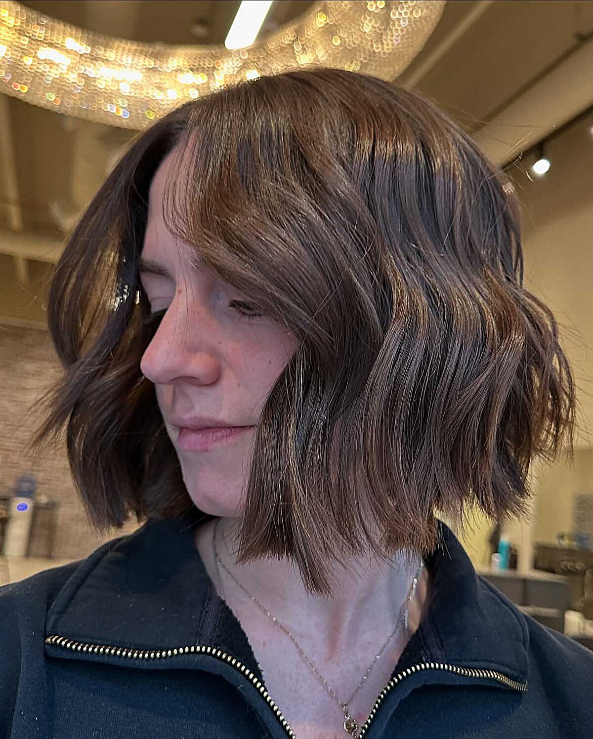 Warm chocolate wavy cowgirl bob with deep side part