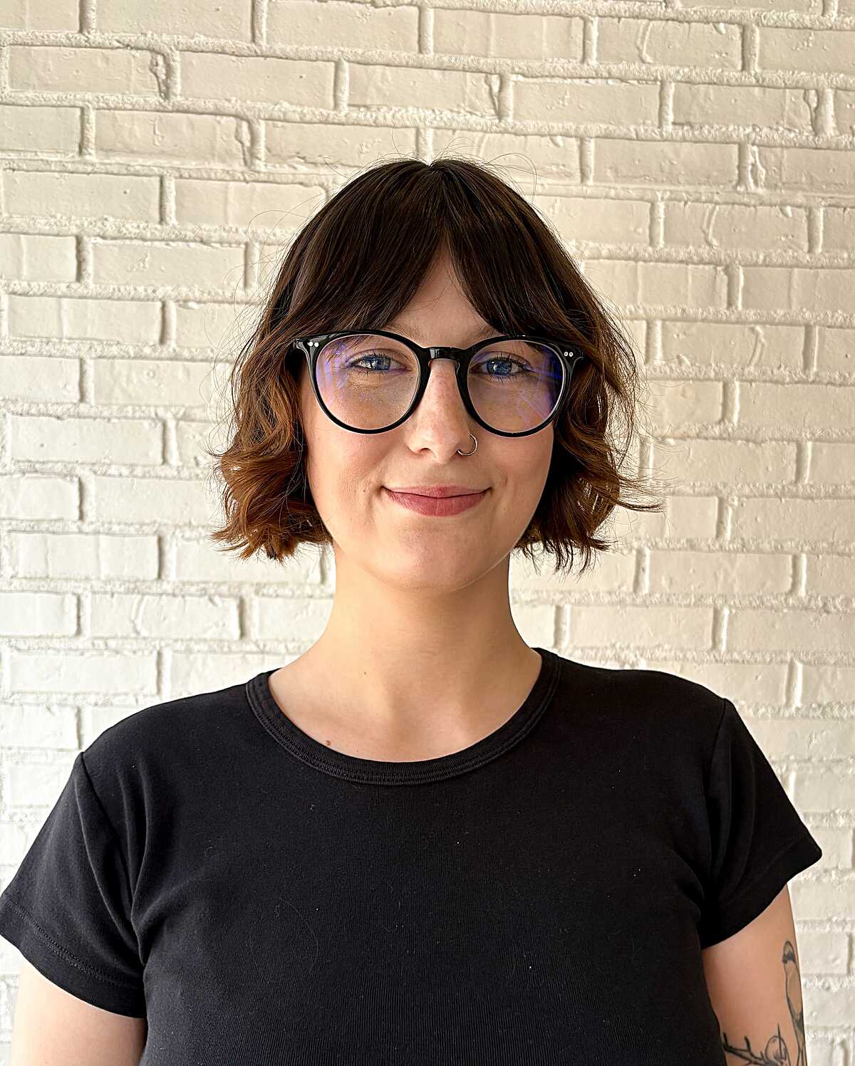 Wavy brunette cowgirl bob with copper tips and glasses