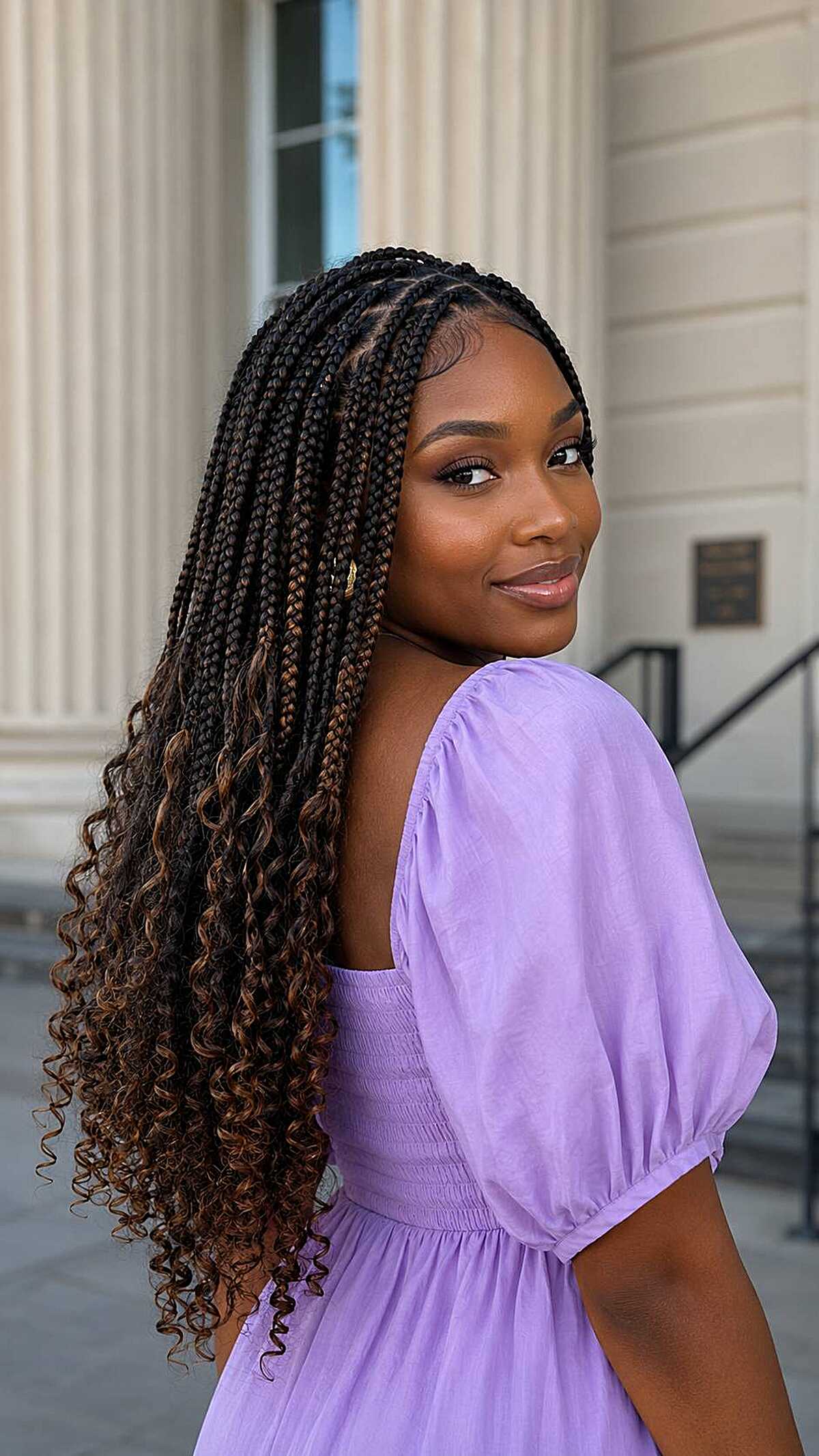Box braids with curly honey-brown ends past shoulders