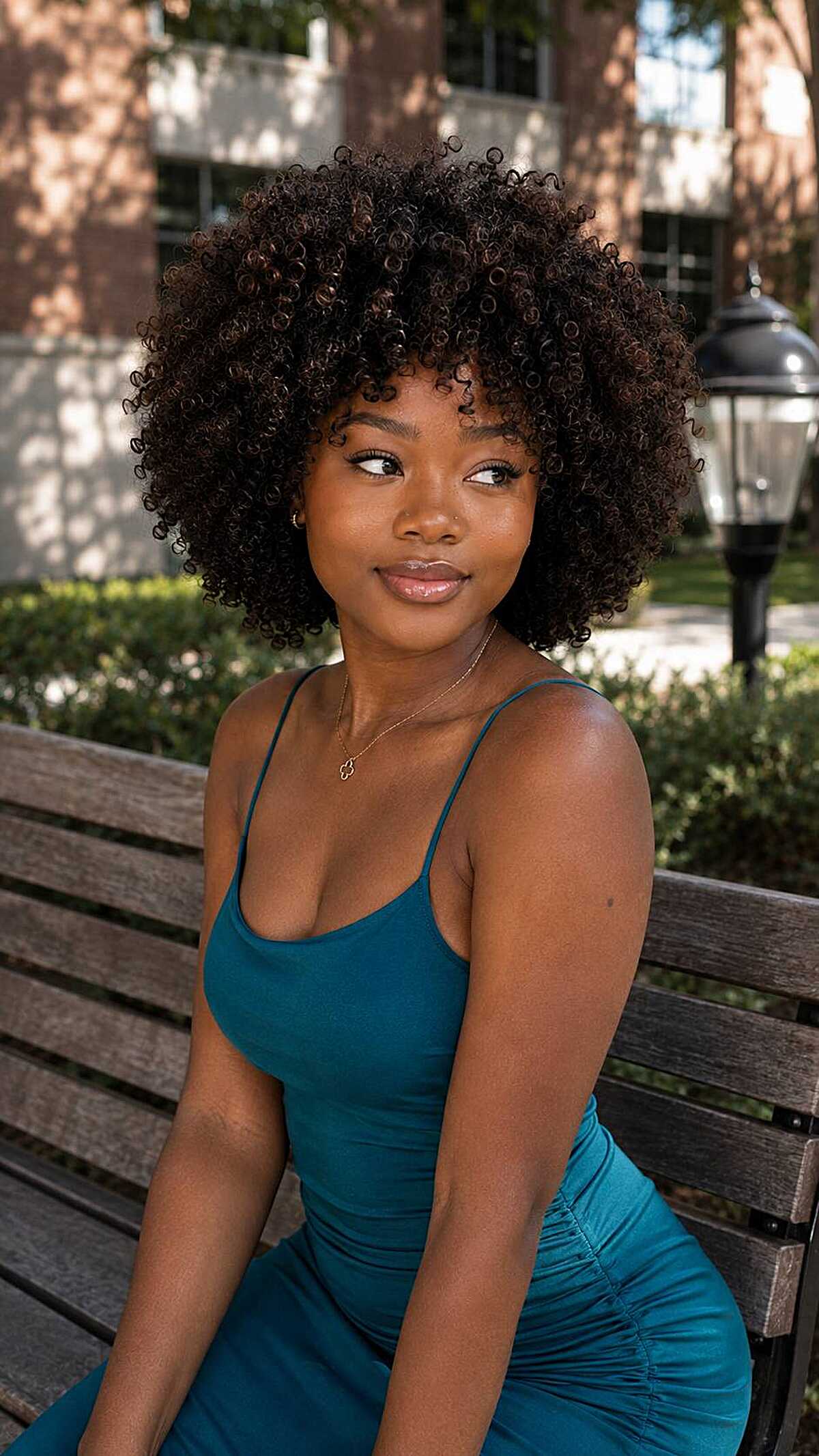 Rounded natural coil-out afro with tight defined curls