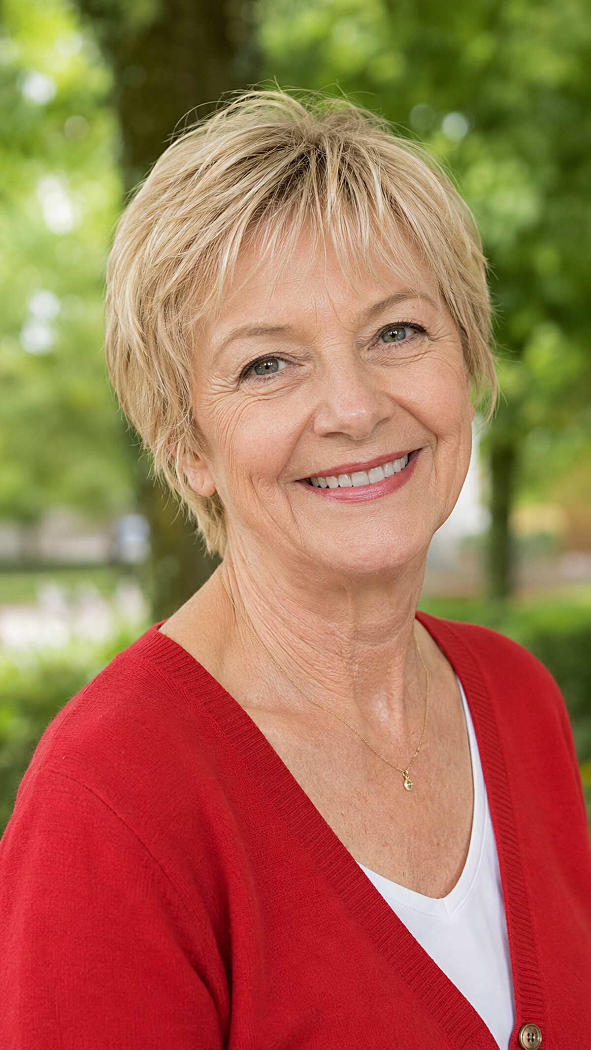 Classic blonde layered pixie with side-swept bangs