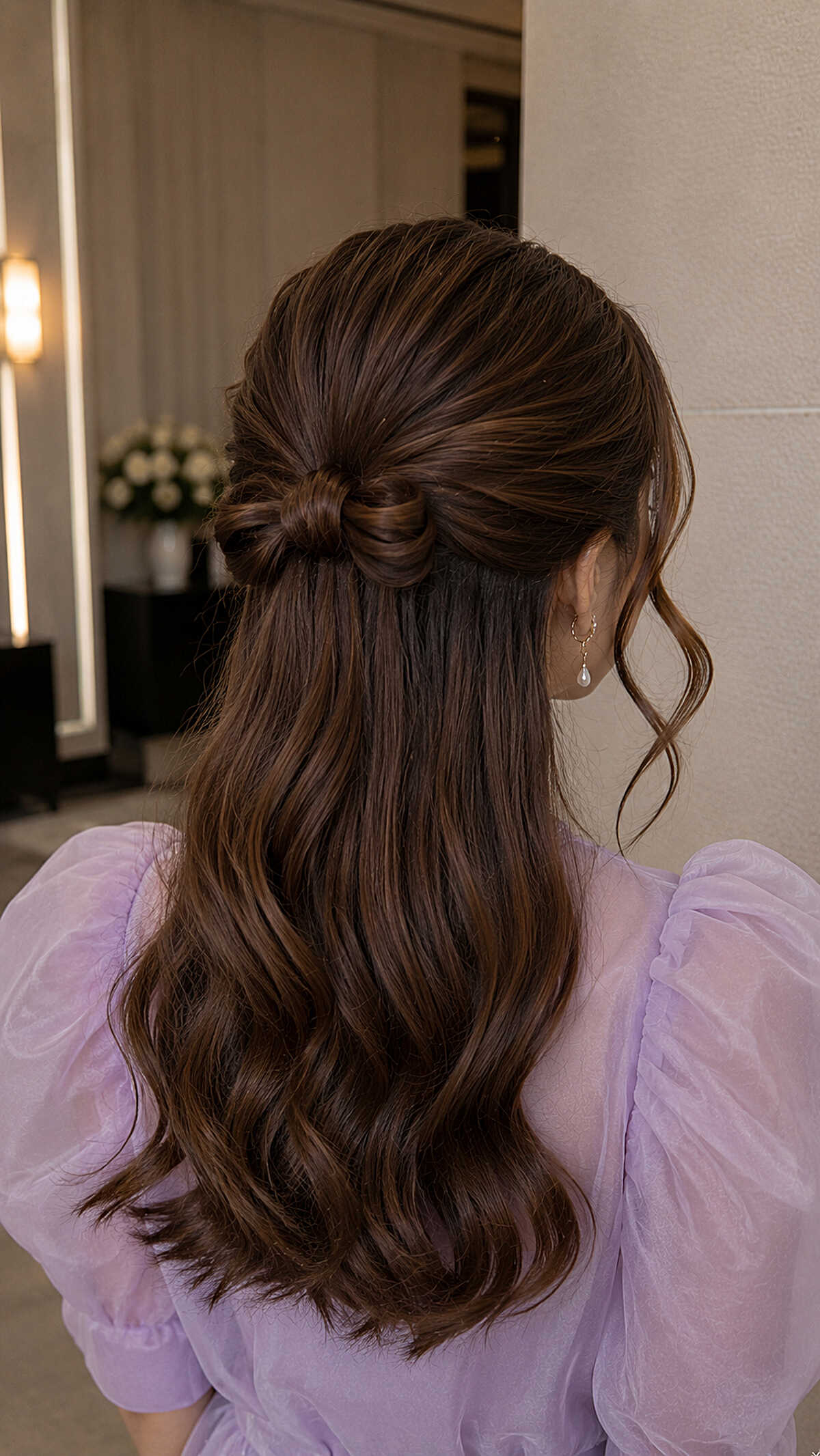 Dark brown half-up with hair bow and lavender dress