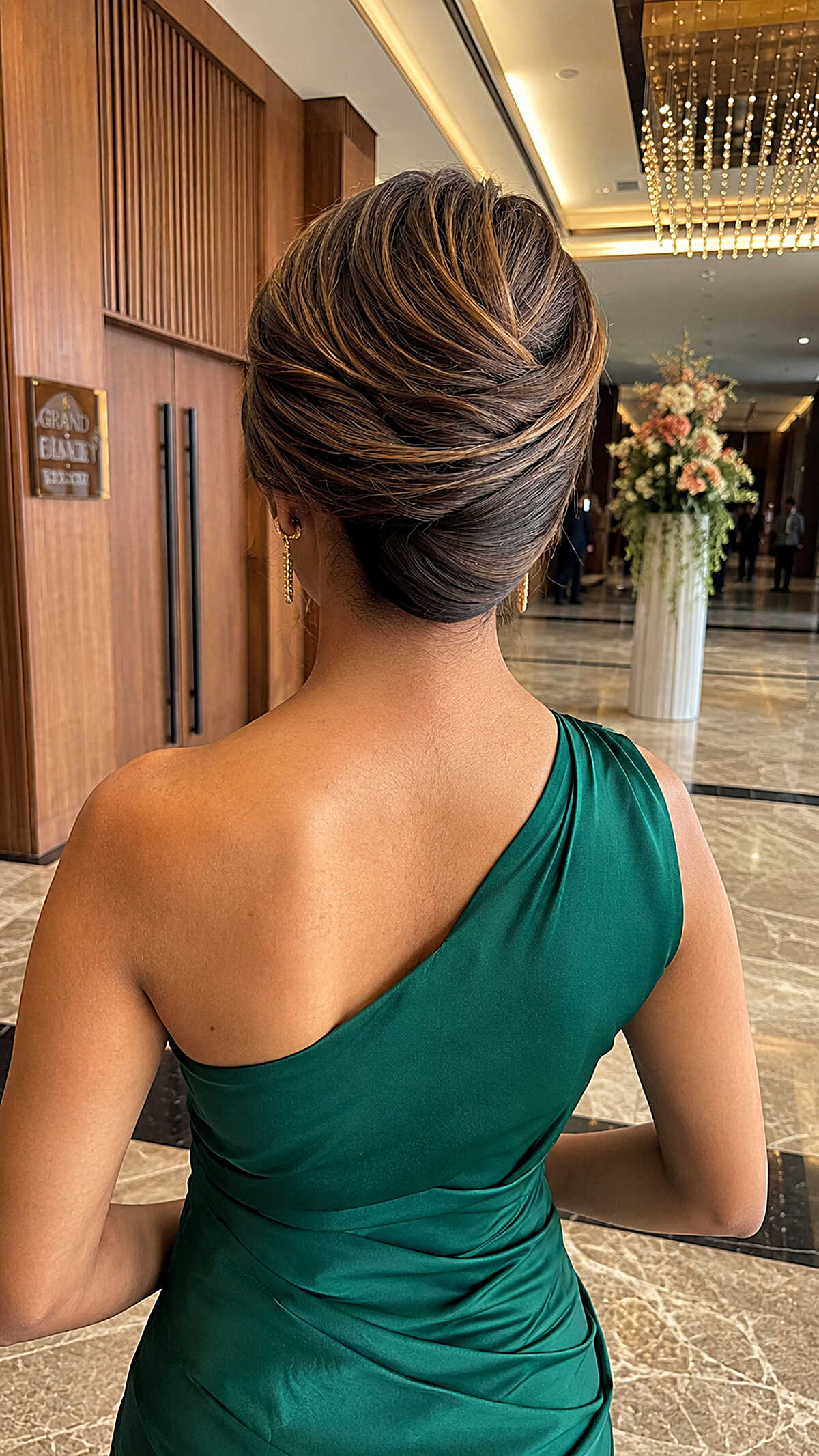 Elegant brunette French twist updo with caramel highlights