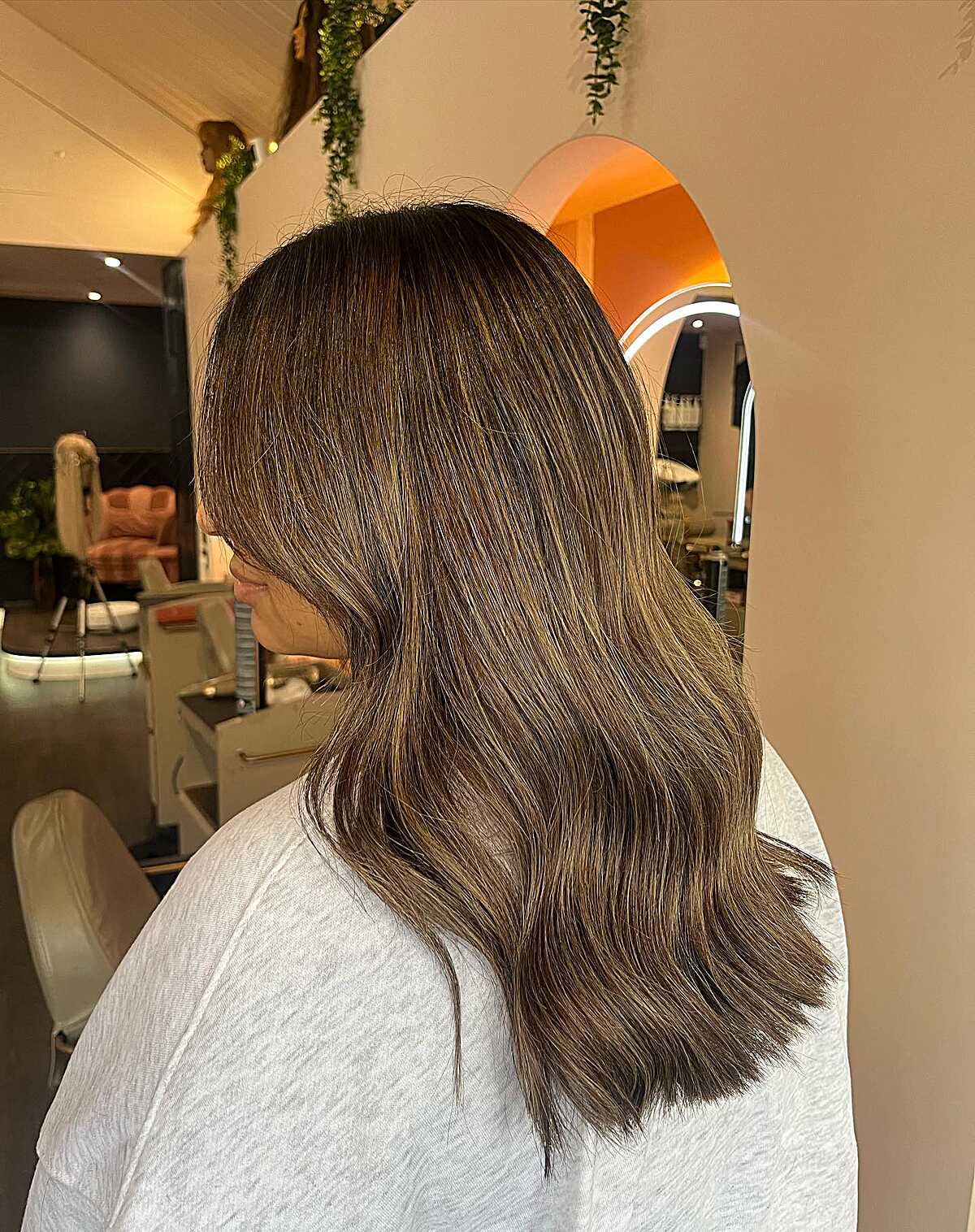 Medium brunette hair with very subtle balayage glints