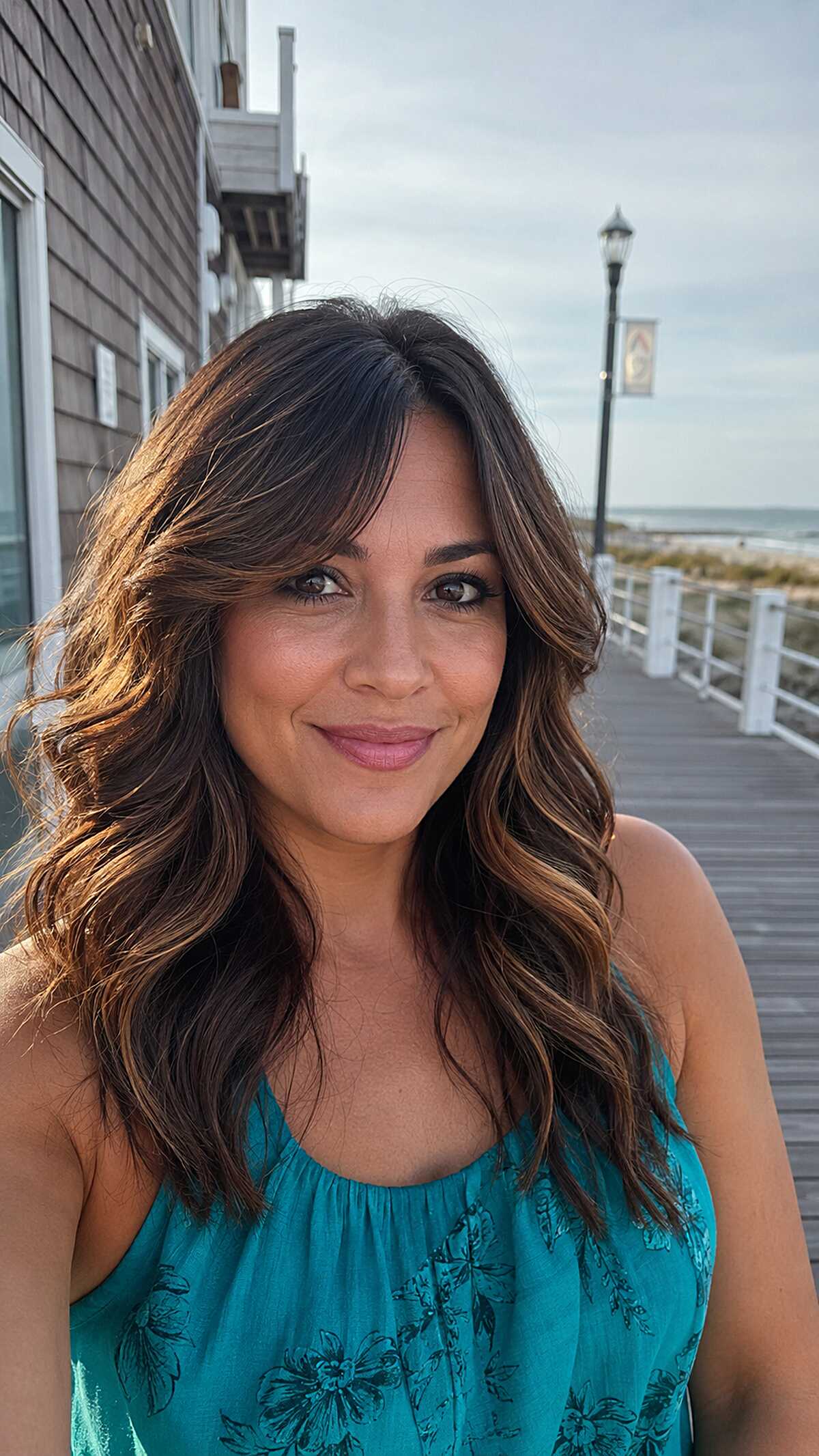 Beachy Brunette Waves with Honey Balayage and Side-Swept Fringe
