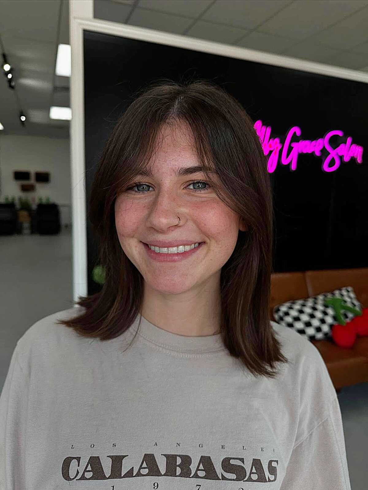 Brunette shoulder-length bob with layered curtain bangs