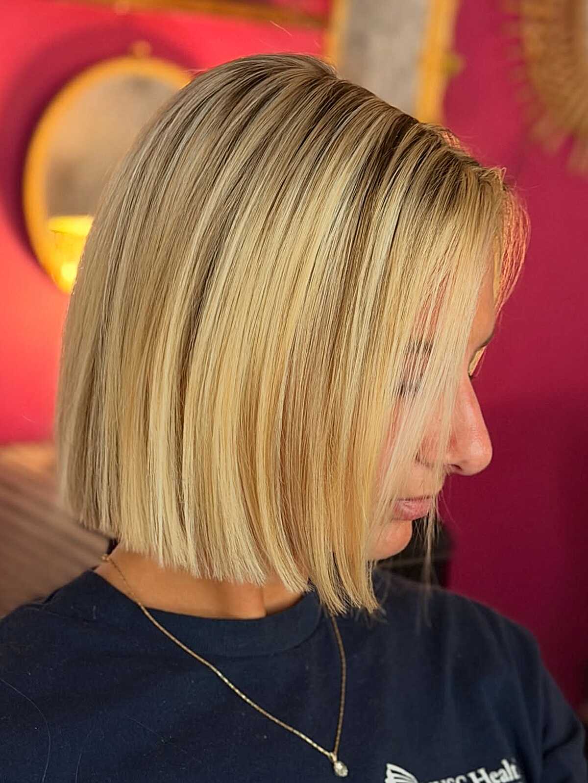 Straight blunt butter blonde bob with dark roots