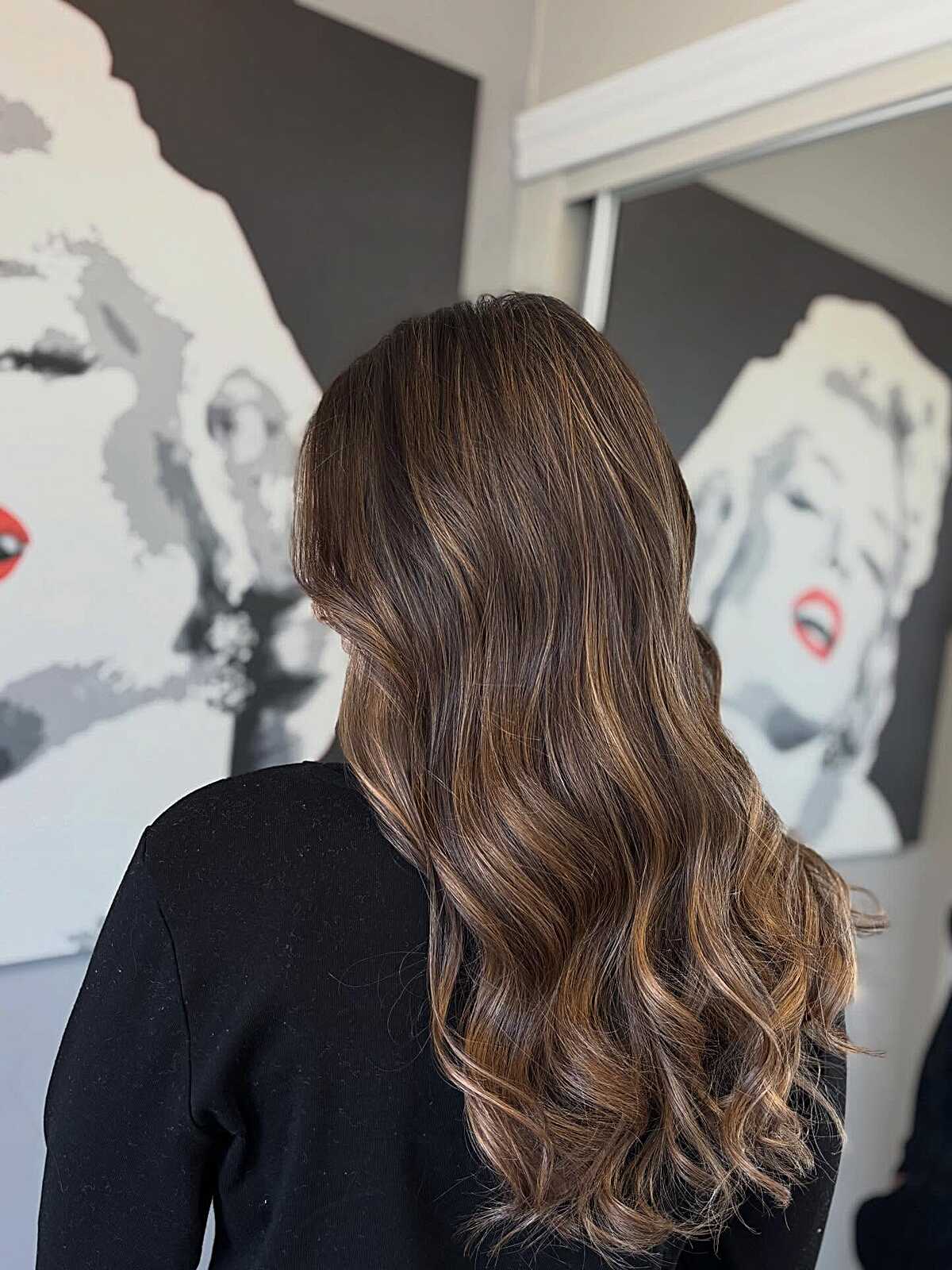 Dark brunette hair with caramel balayage and bouncy ends