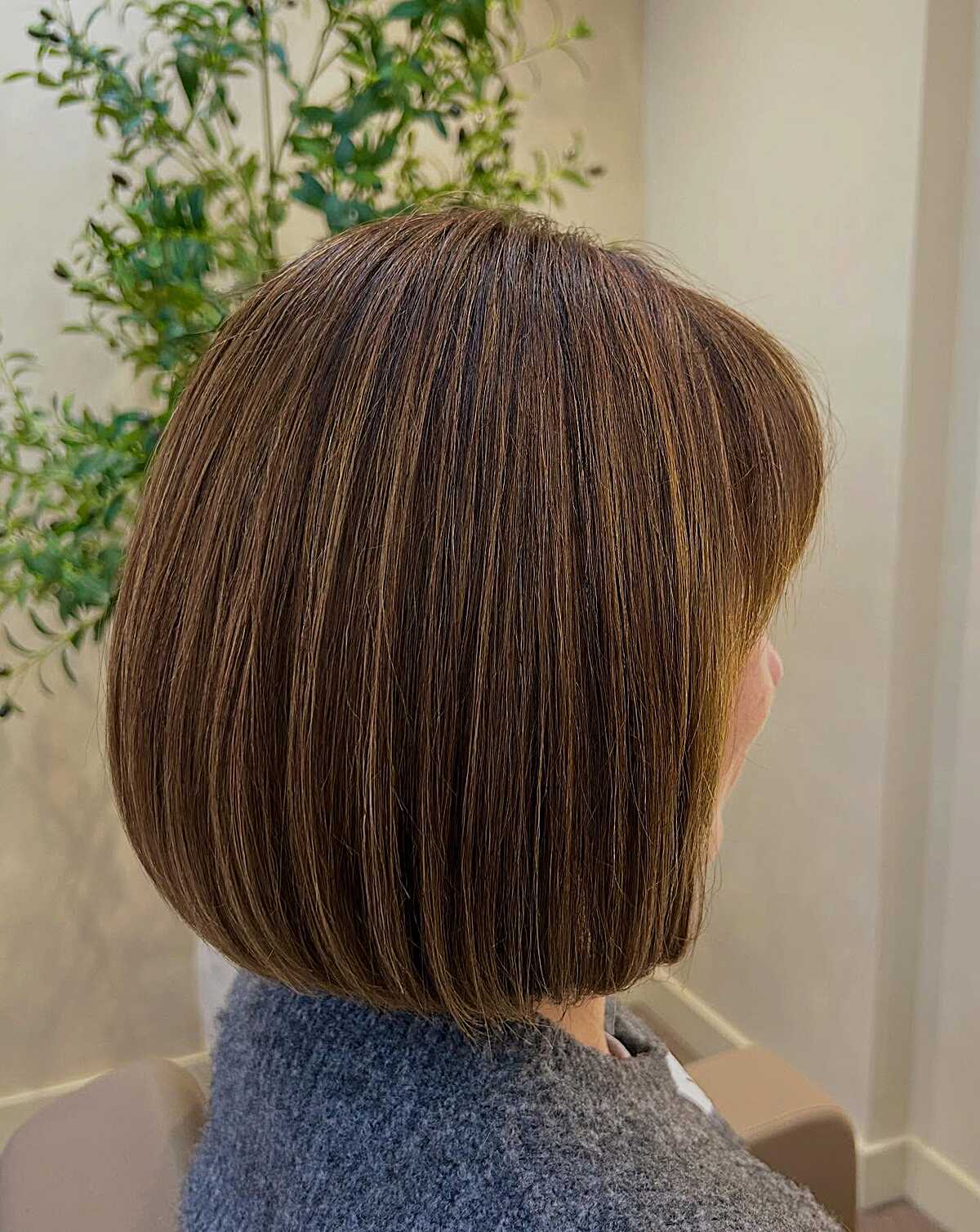 Chin-length brunette bob with subtle warm balayage