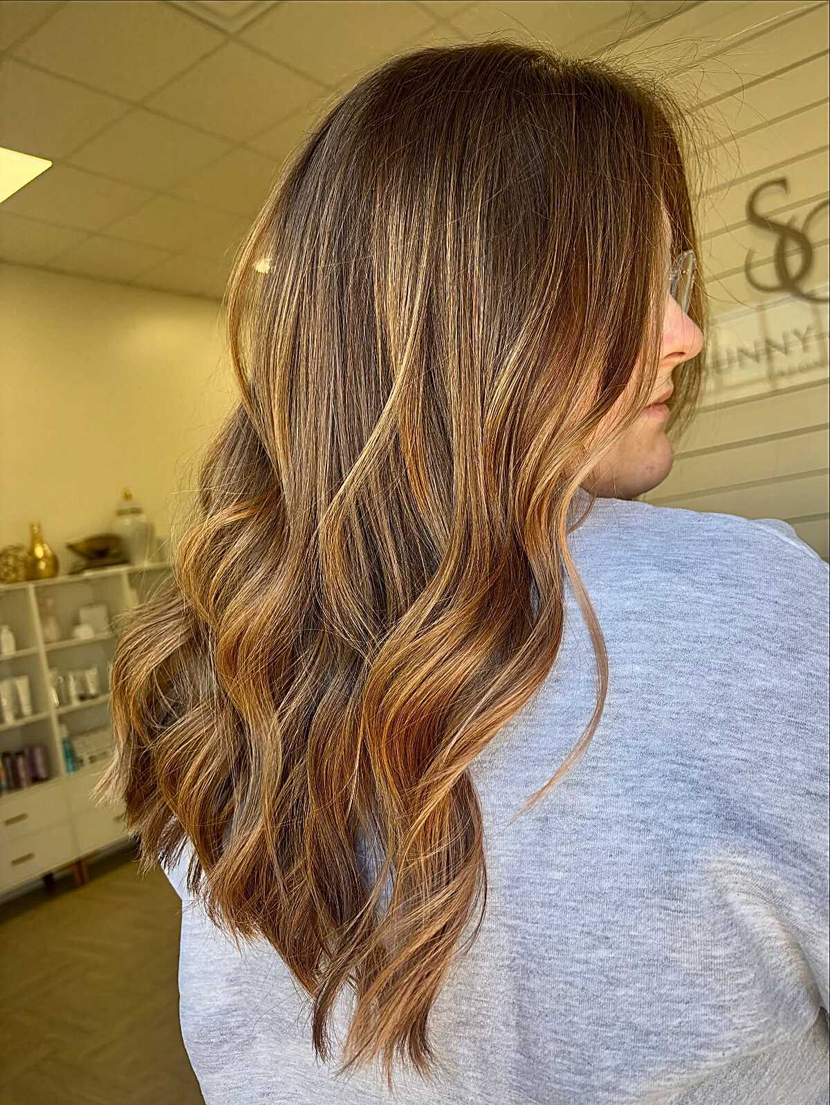Medium-length brunette with warm copper balayage pieces