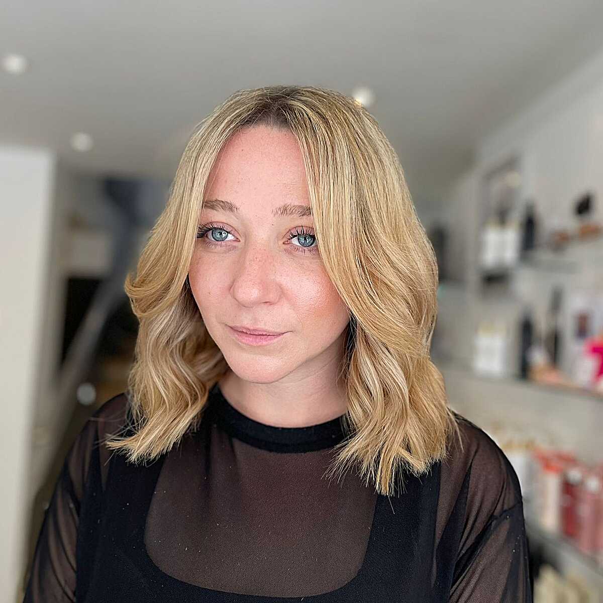Golden honey blonde wavy lob with soft side part