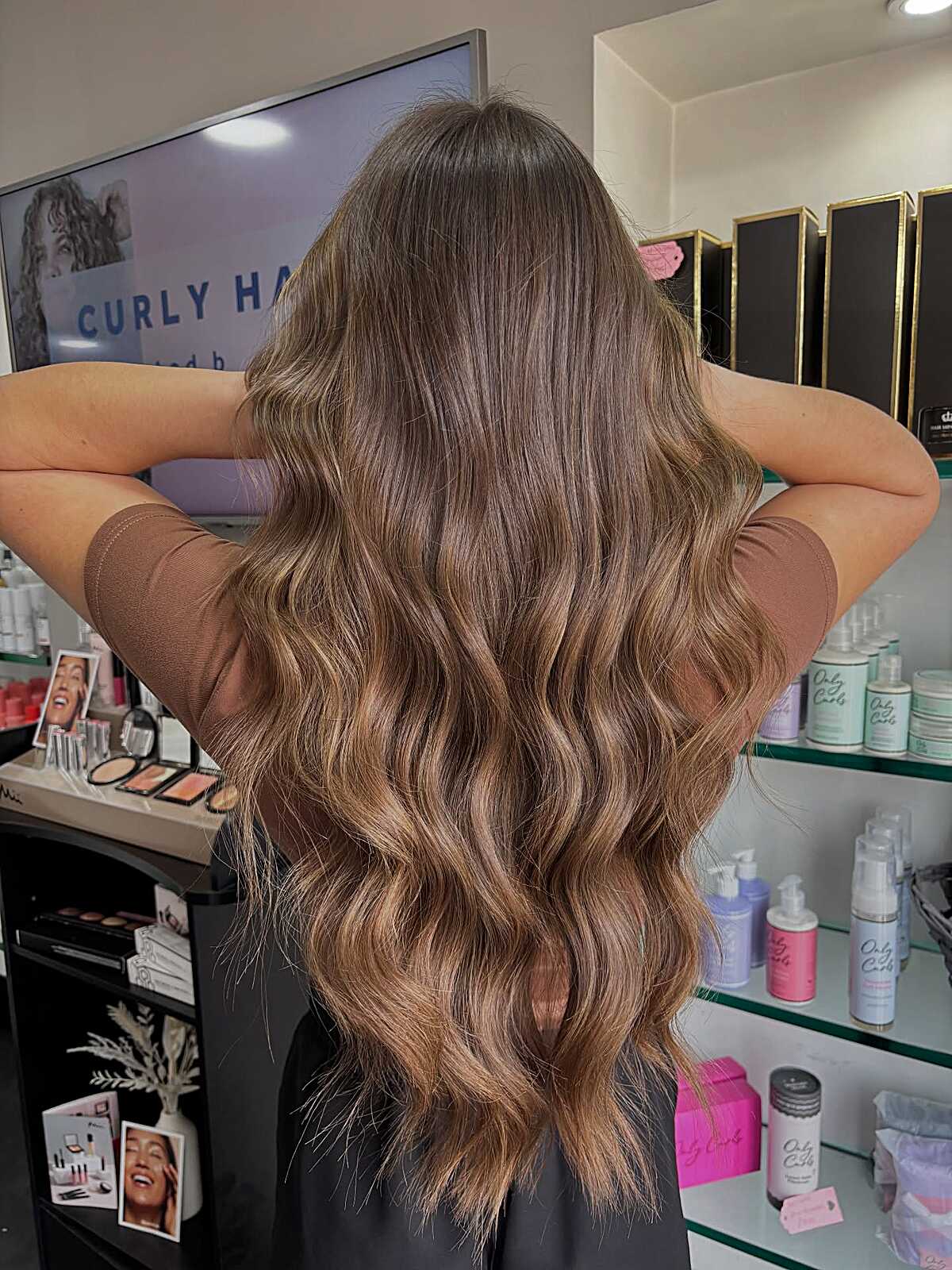 Long brunette balayage with honey tones and soft waves