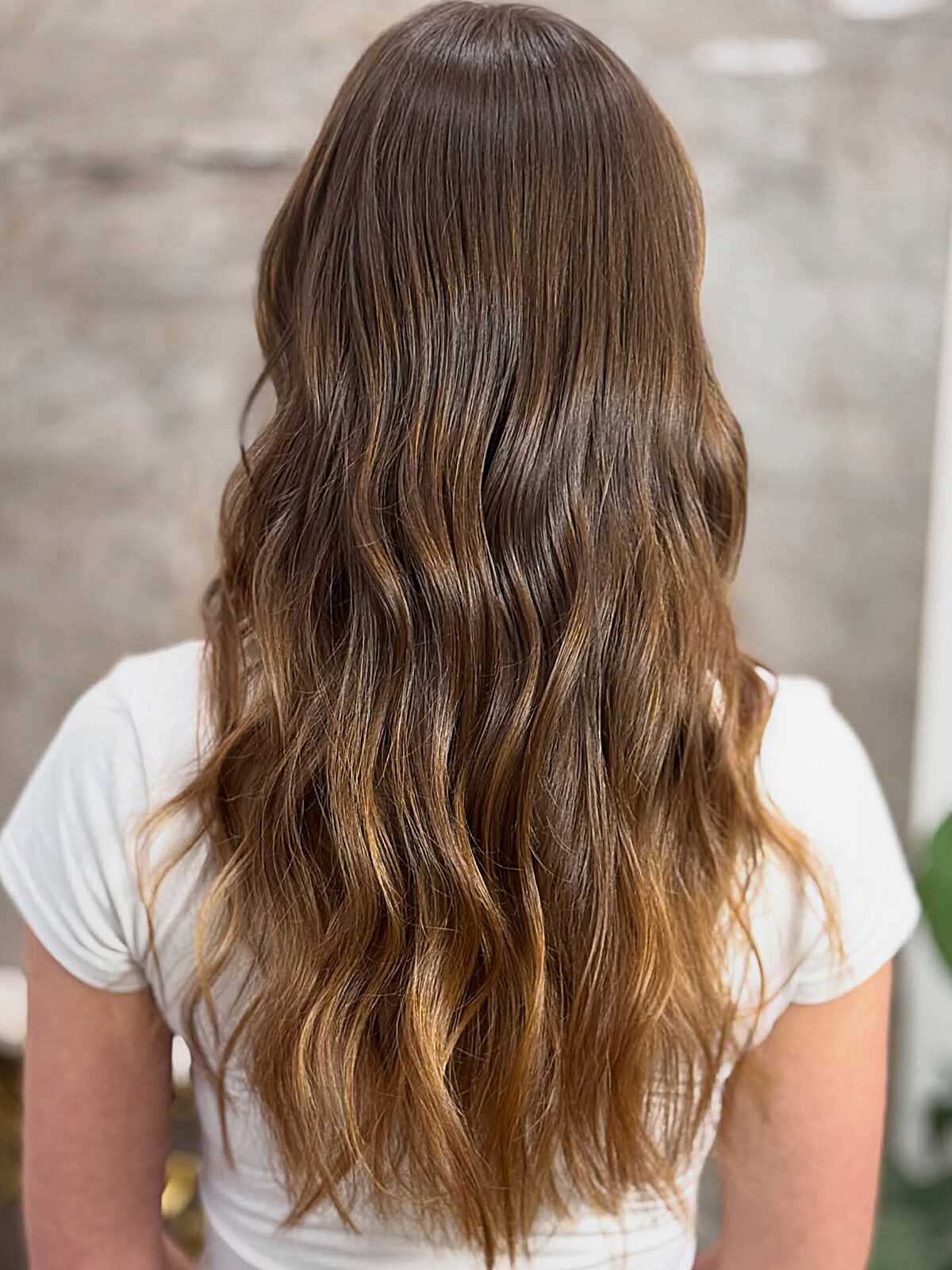 Long brunette hair with gentle balayage fade at ends