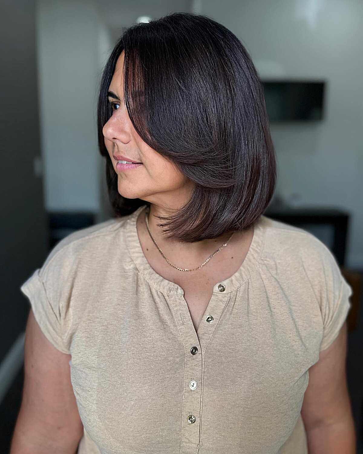 Glossy dark brown bob with flipped-out ends and layers