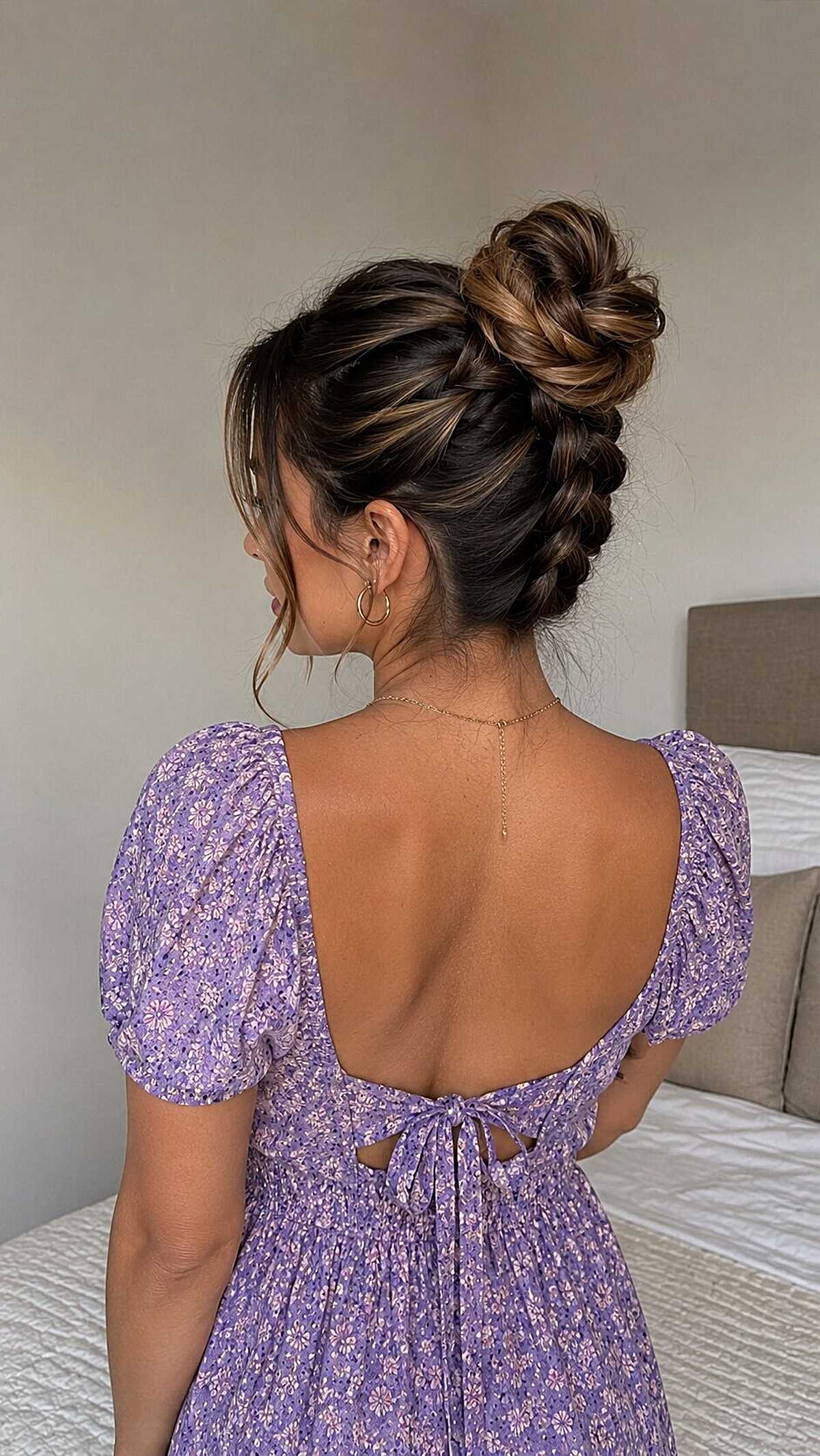 Reverse French braid leading into a high messy bun