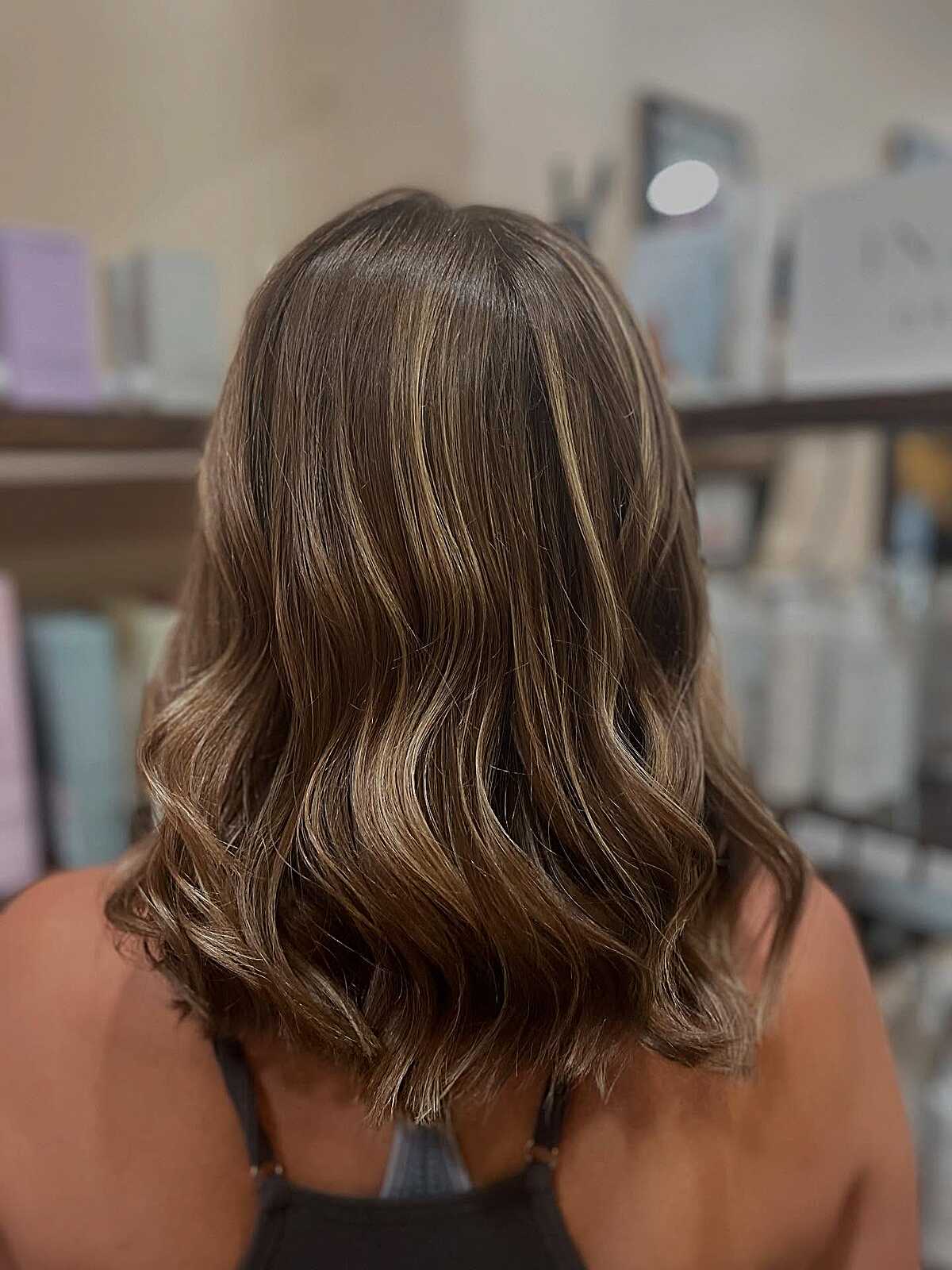 Shoulder-length brunette lob with sandy blonde balayage