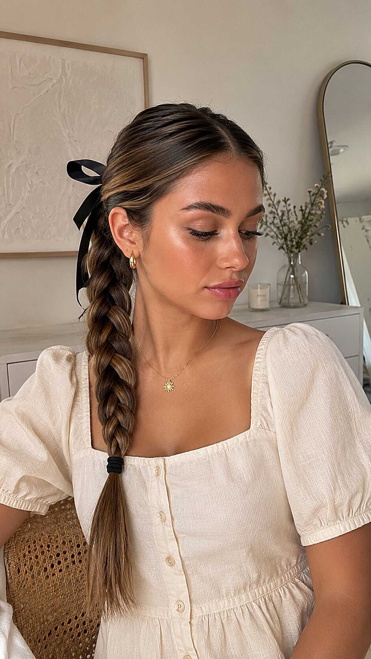 Side French braid with black satin ribbon bow