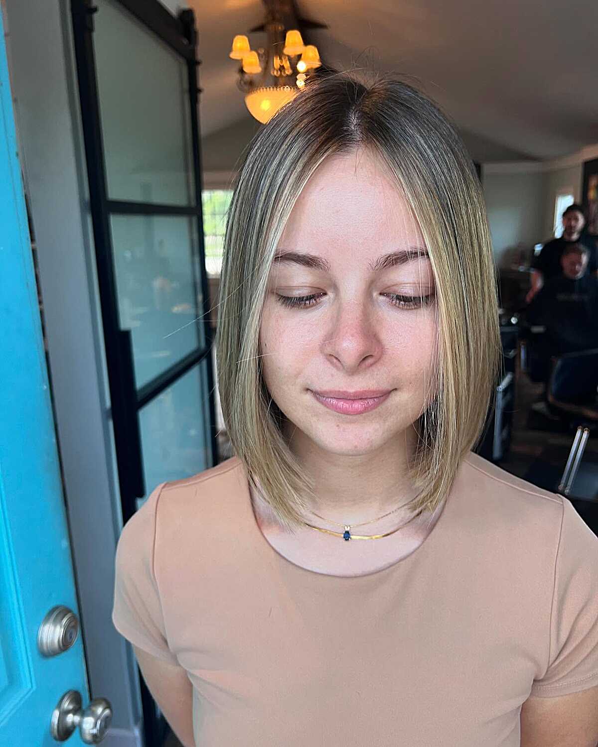Sleek straight ash blonde bob with center part