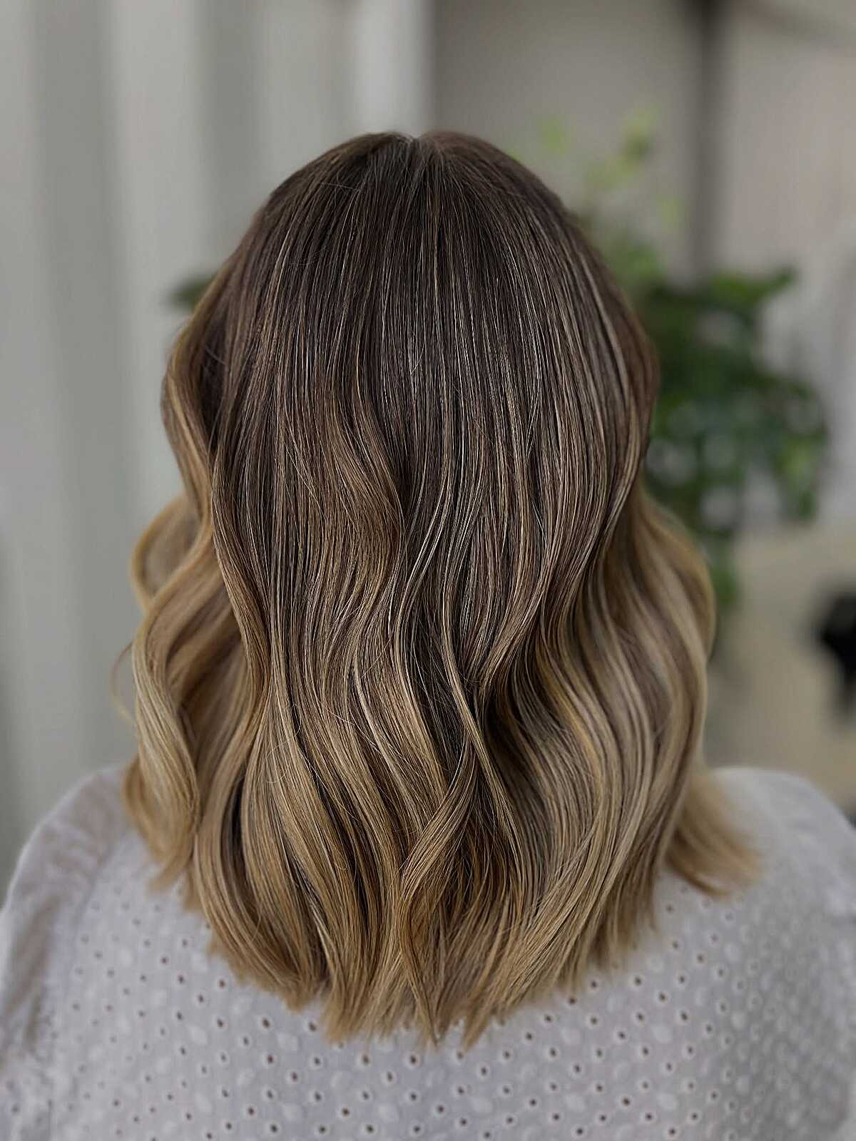 Shoulder-length lob with soft bronde balayage color melt