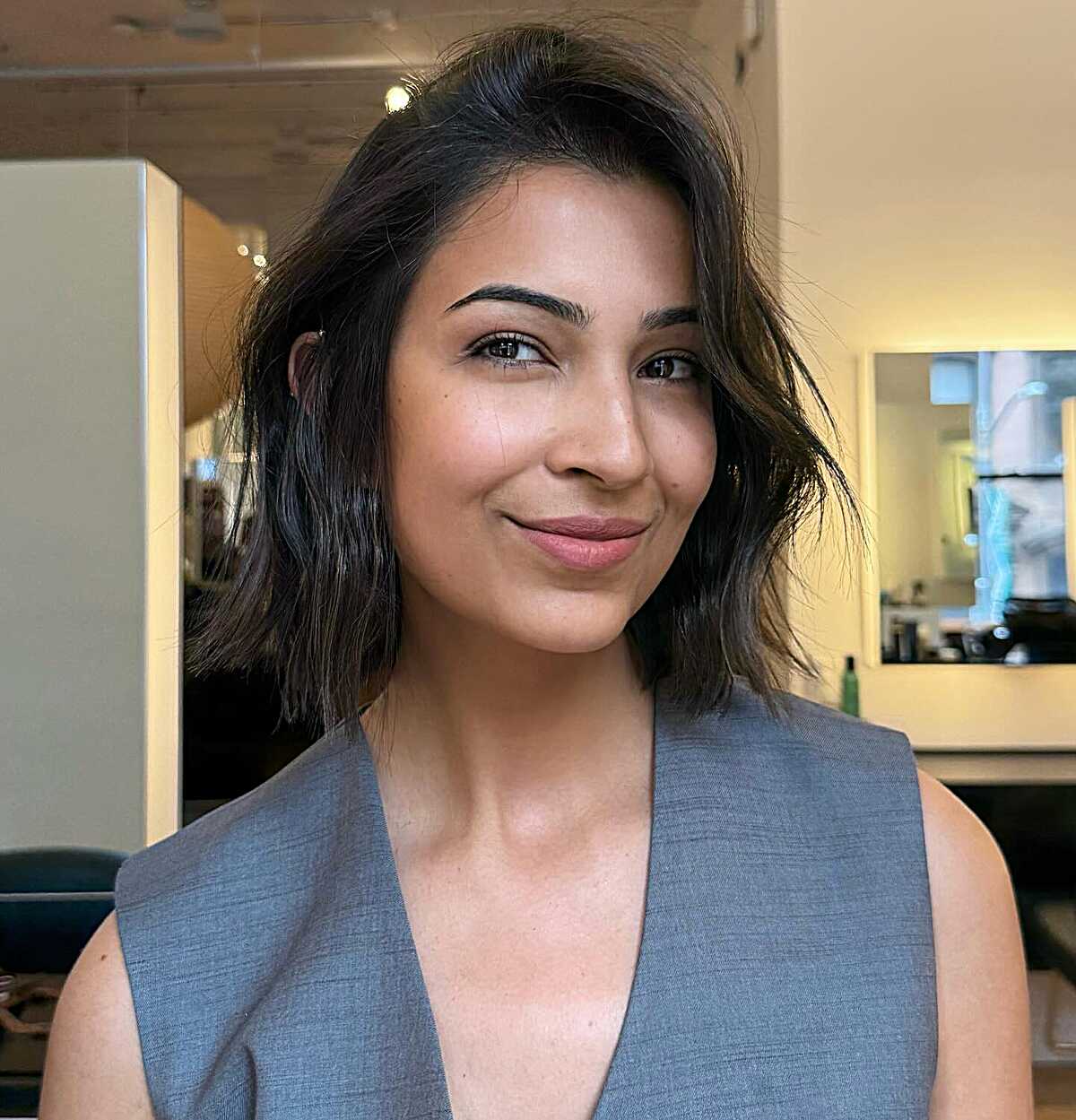 Dark brunette chin-length bob with undone textured waves