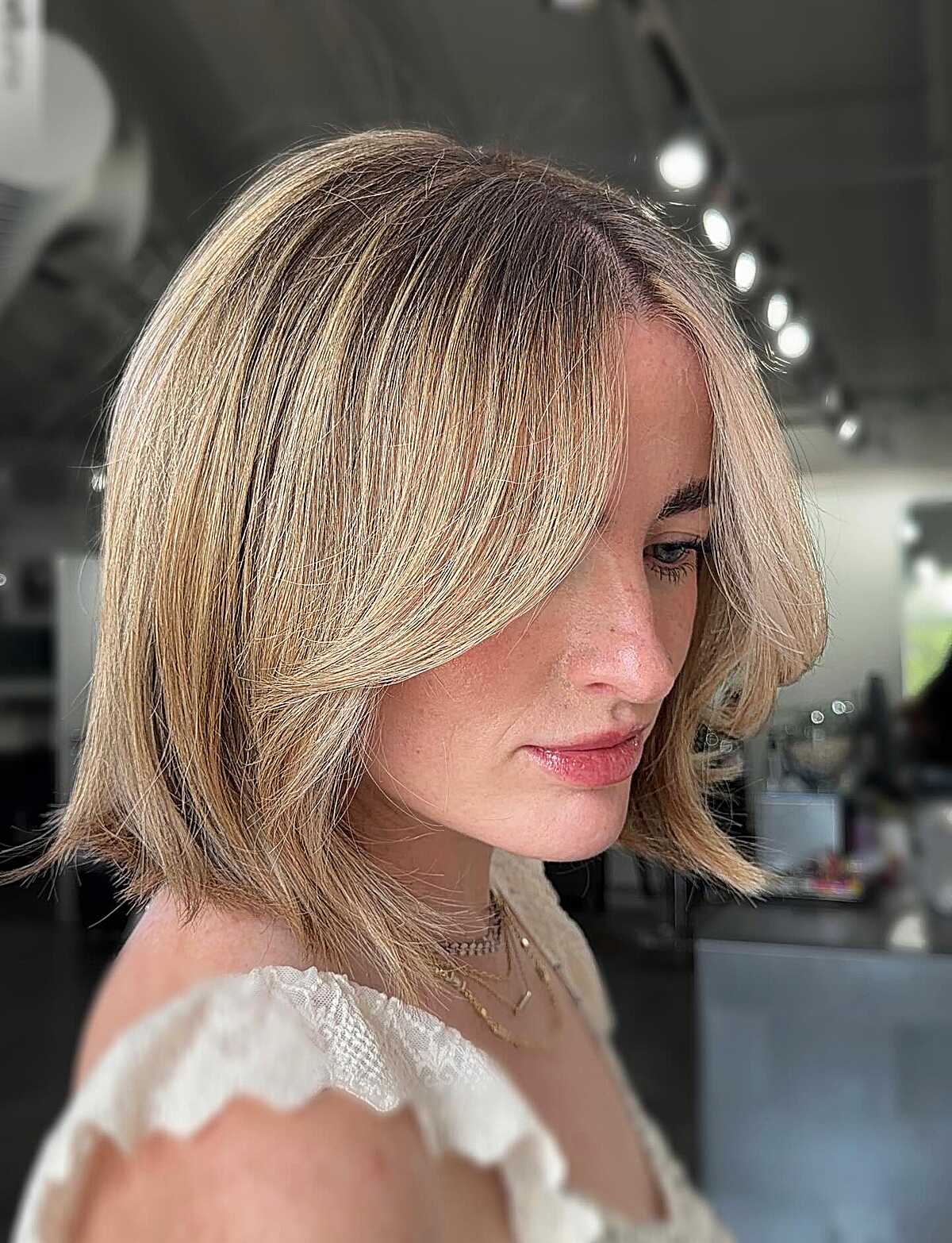 Warm blonde chin-length bob with face-framing layers