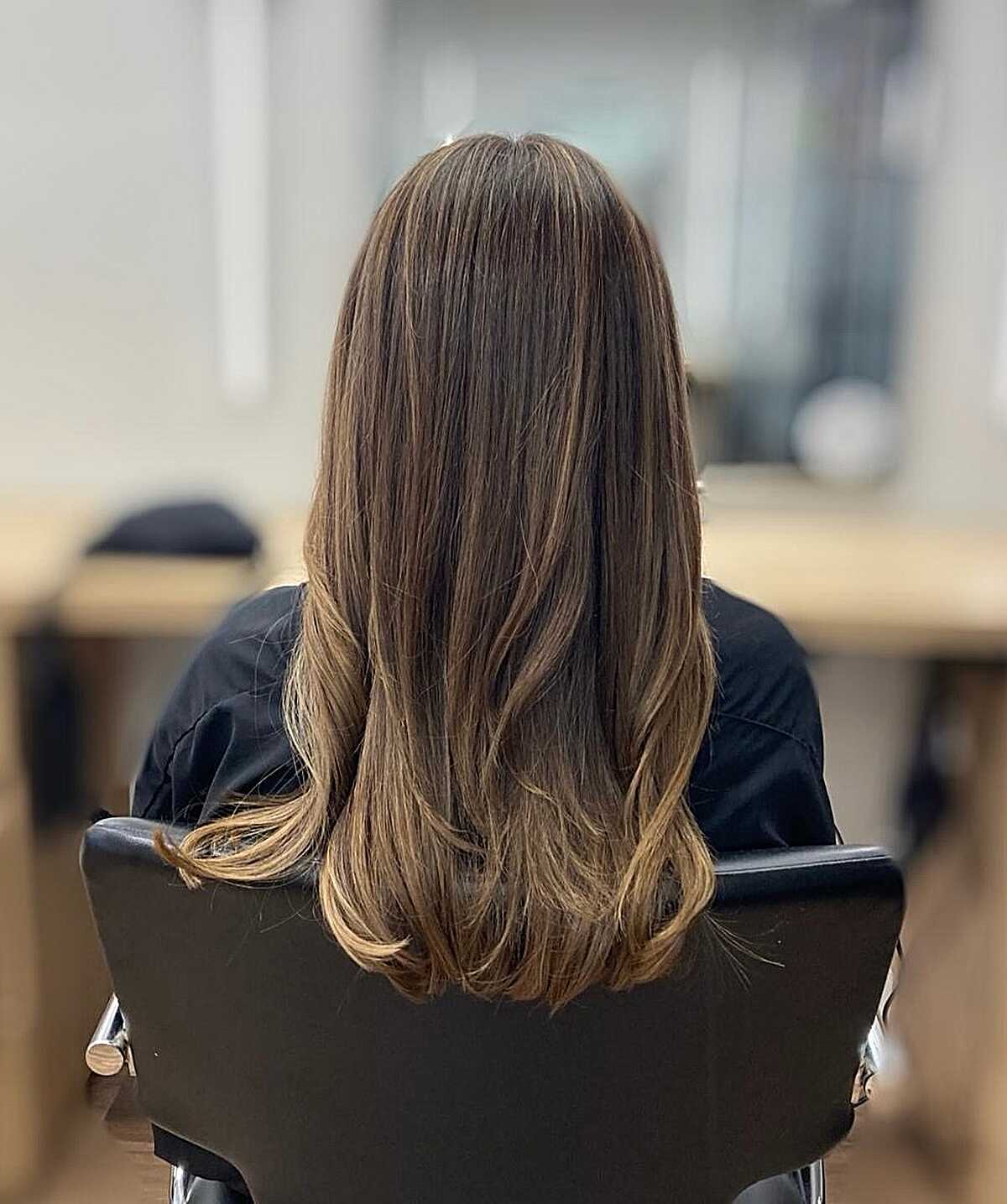 Medium brunette with warm honey balayage and blowout