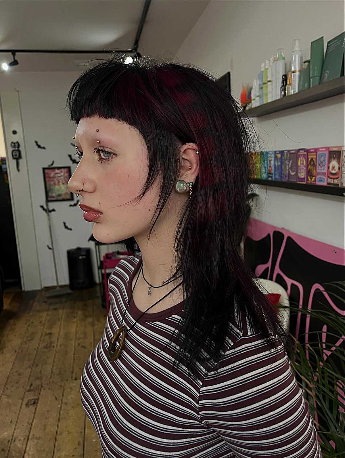Burgundy and black mullet with choppy micro bangs