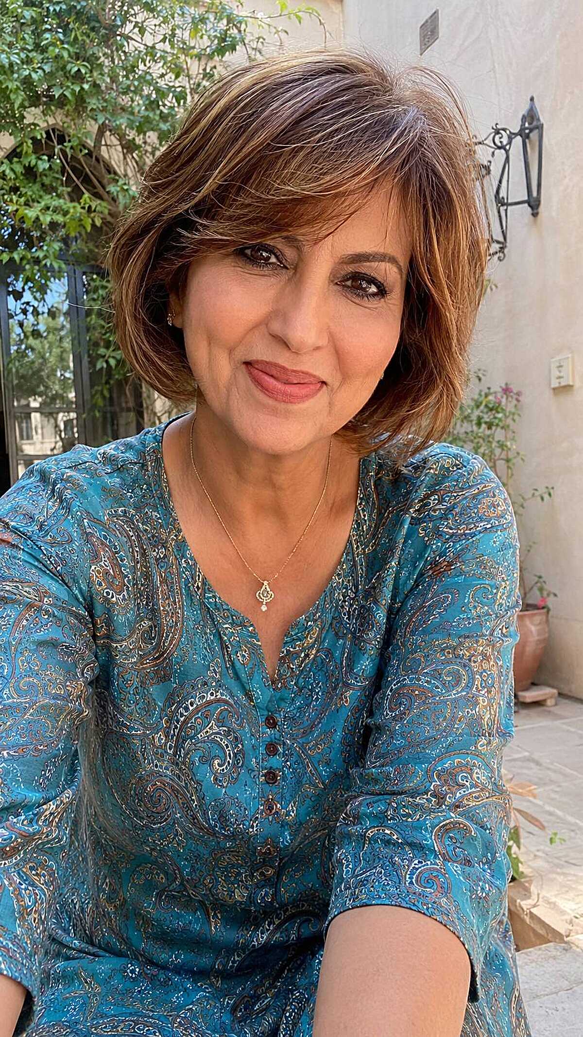 Cinnamon brown layered chin bob with feathered ends