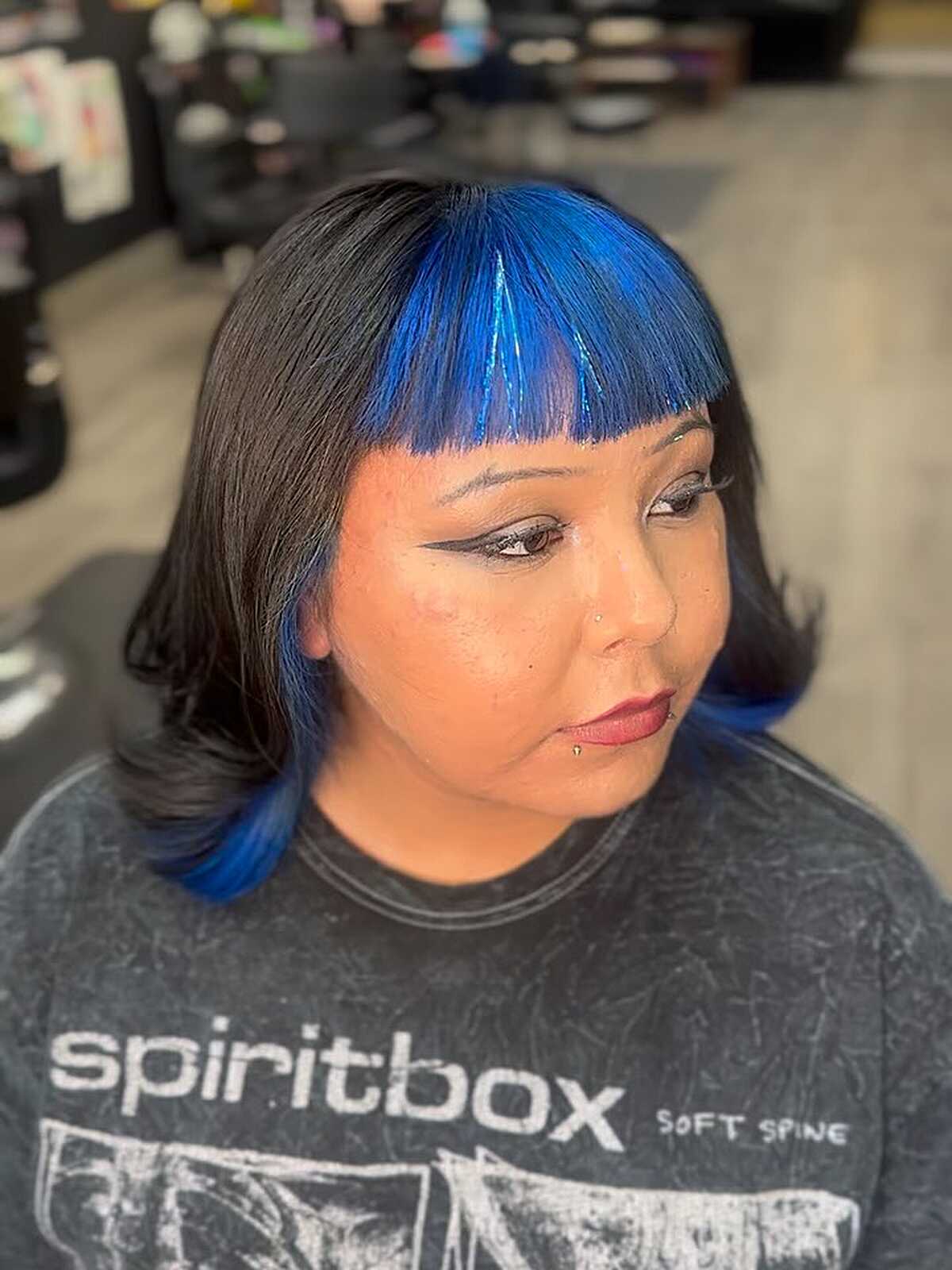 Dark blunt bob with electric blue micro bangs and tips