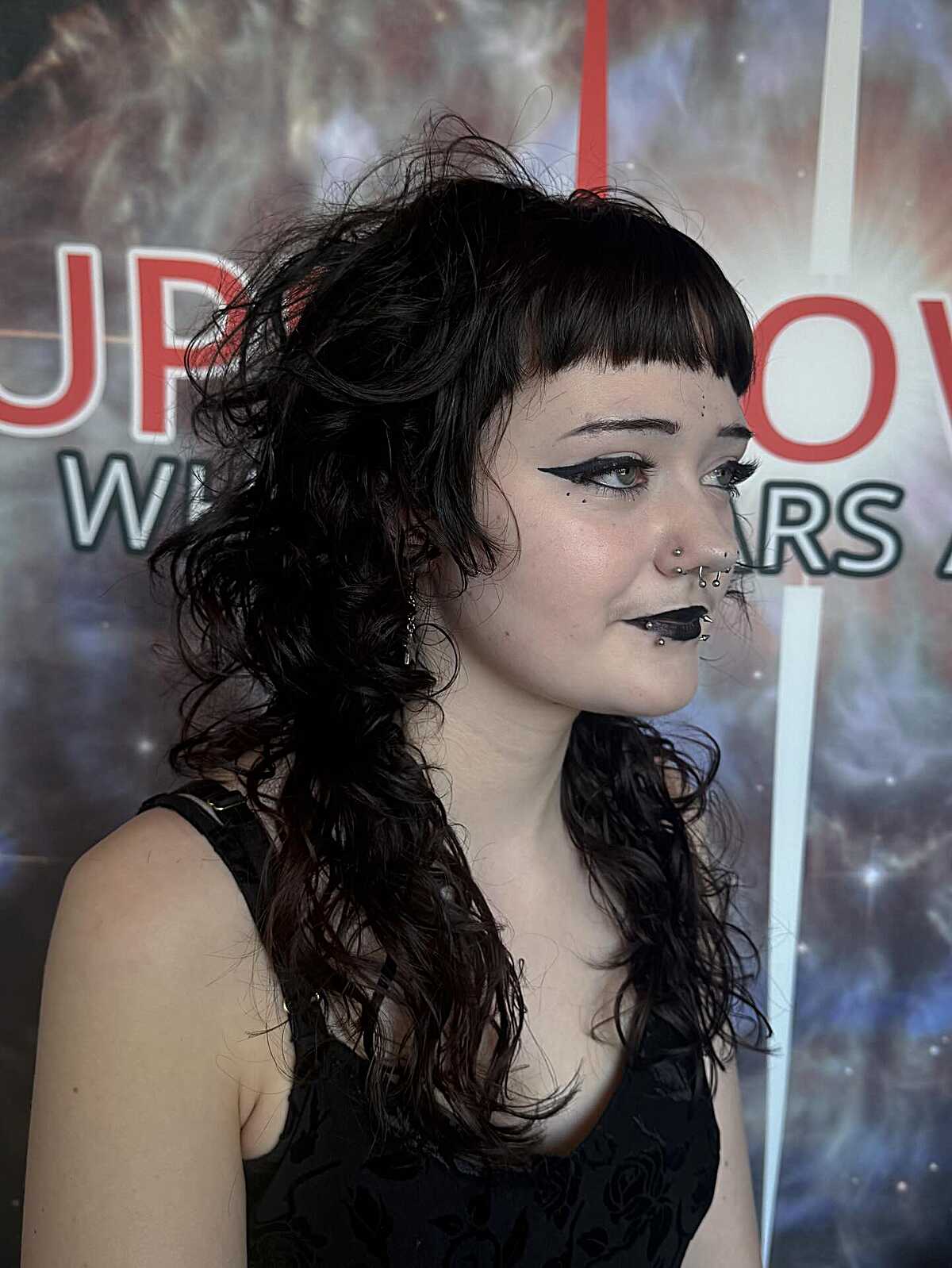 Long curly black hair with blunt short gothic fringe
