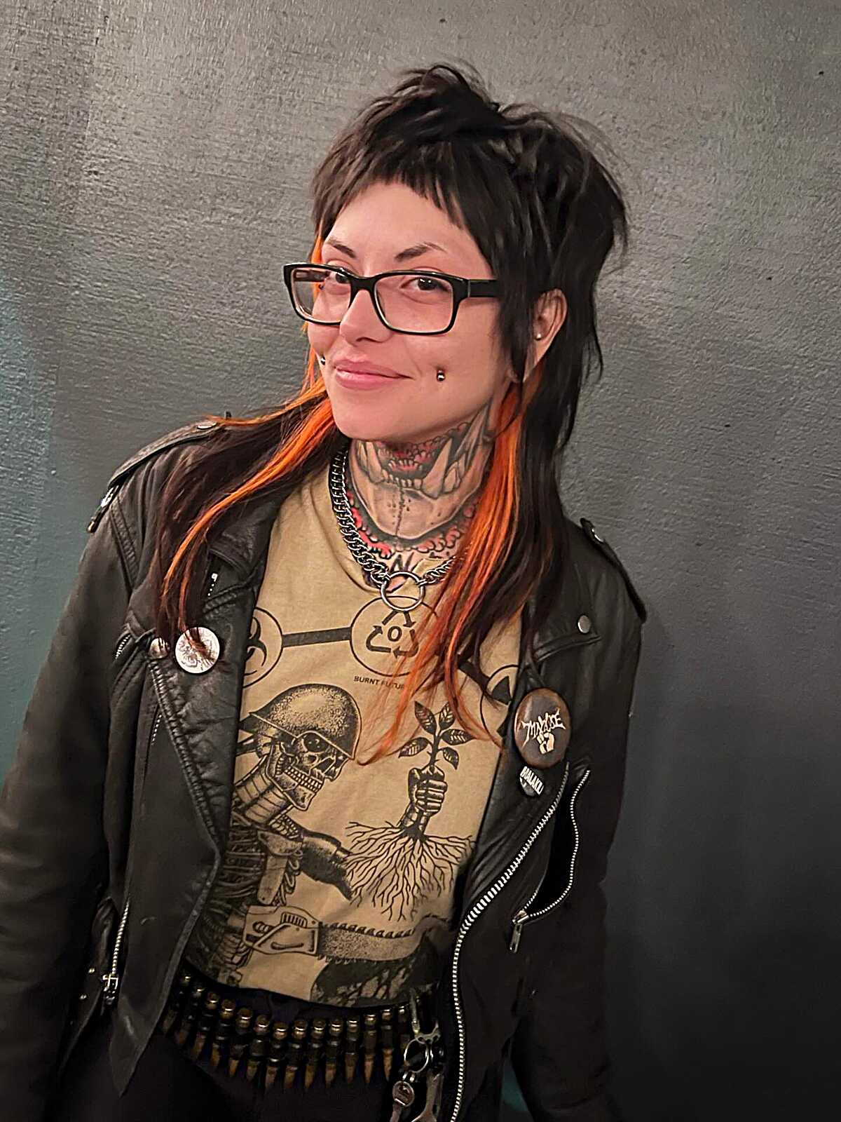 Dark punk half-up style with micro bangs and orange ends