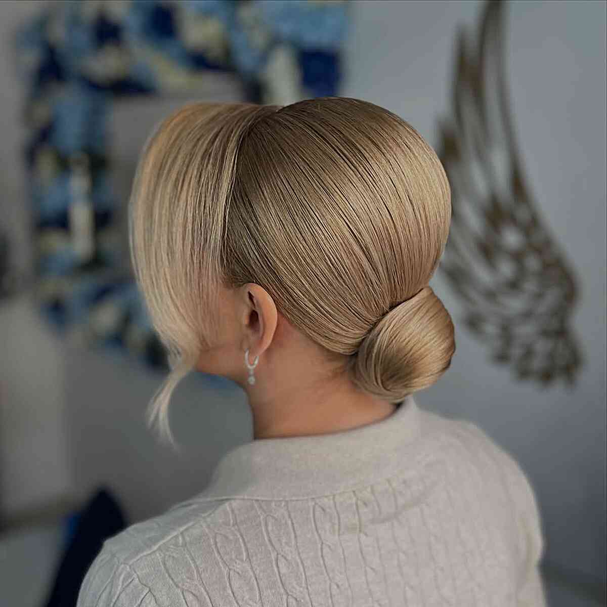 Sleek Low Bun with Side-Swept Bangs