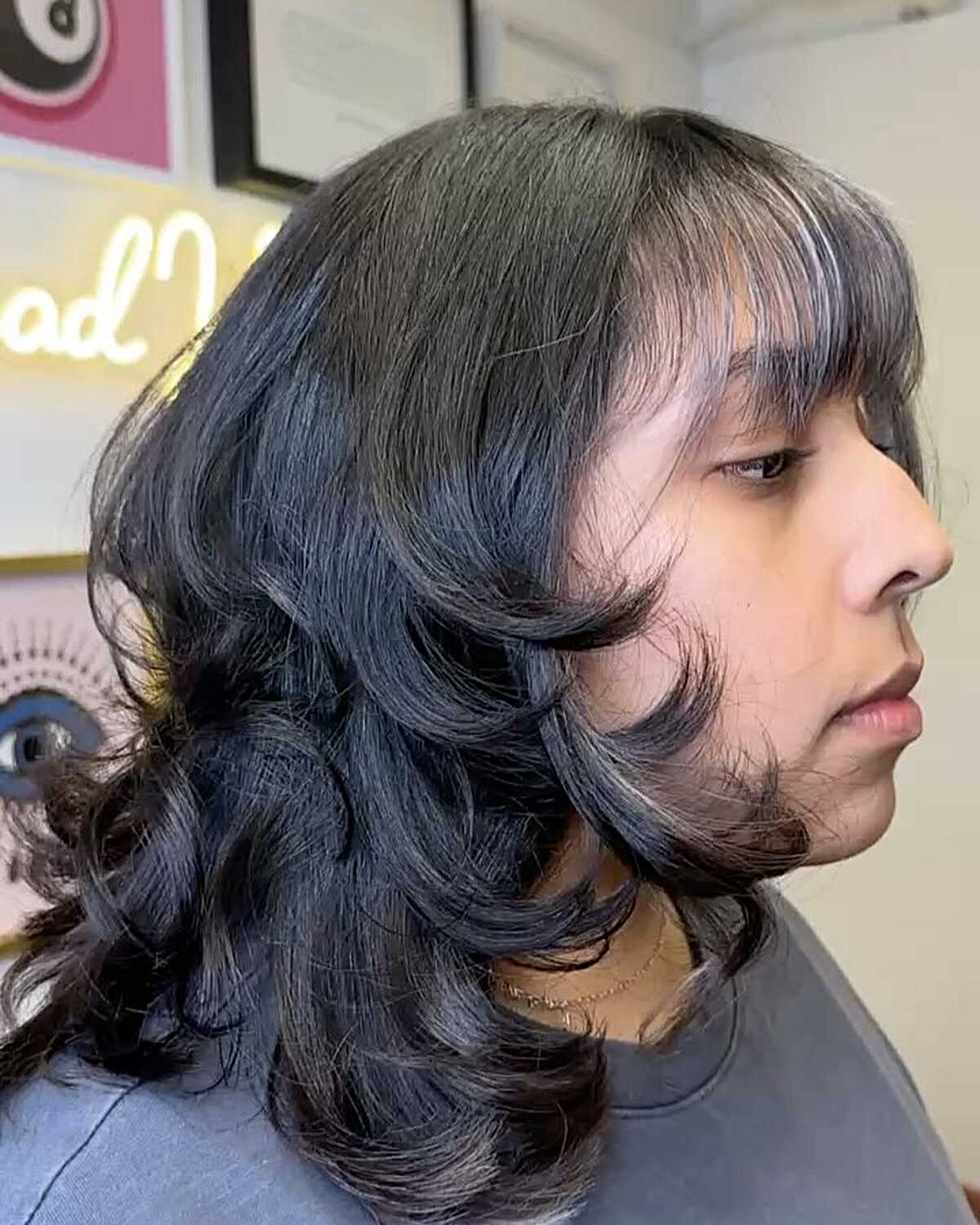 Black curly blowout with bangs and roller-set waves