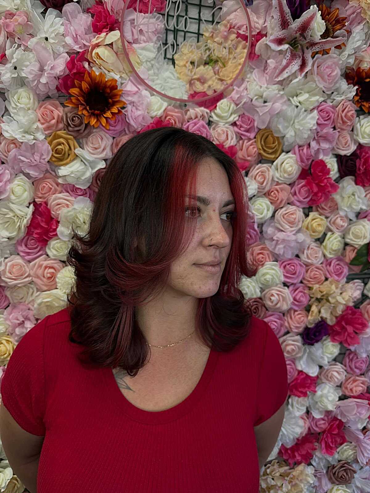 Dark hair with red face-framing highlights and blowout