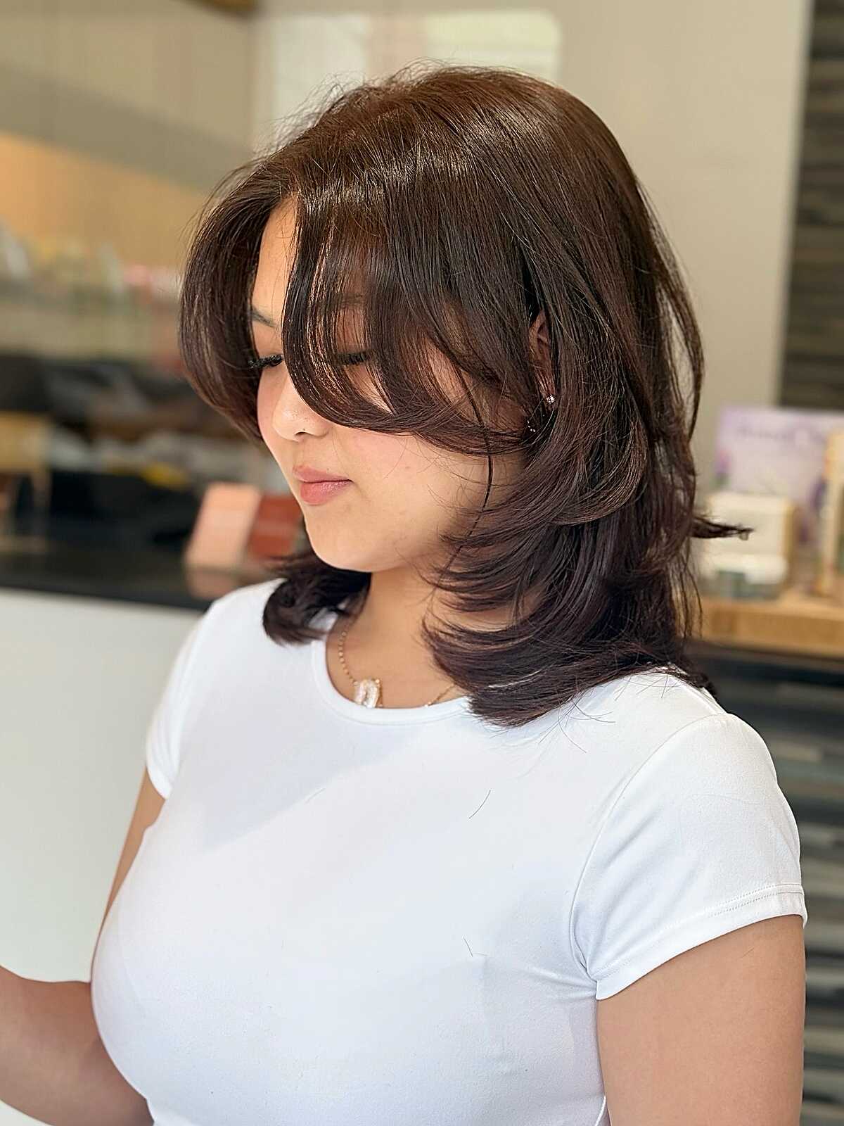Dark brown layered shag blowout with side bangs