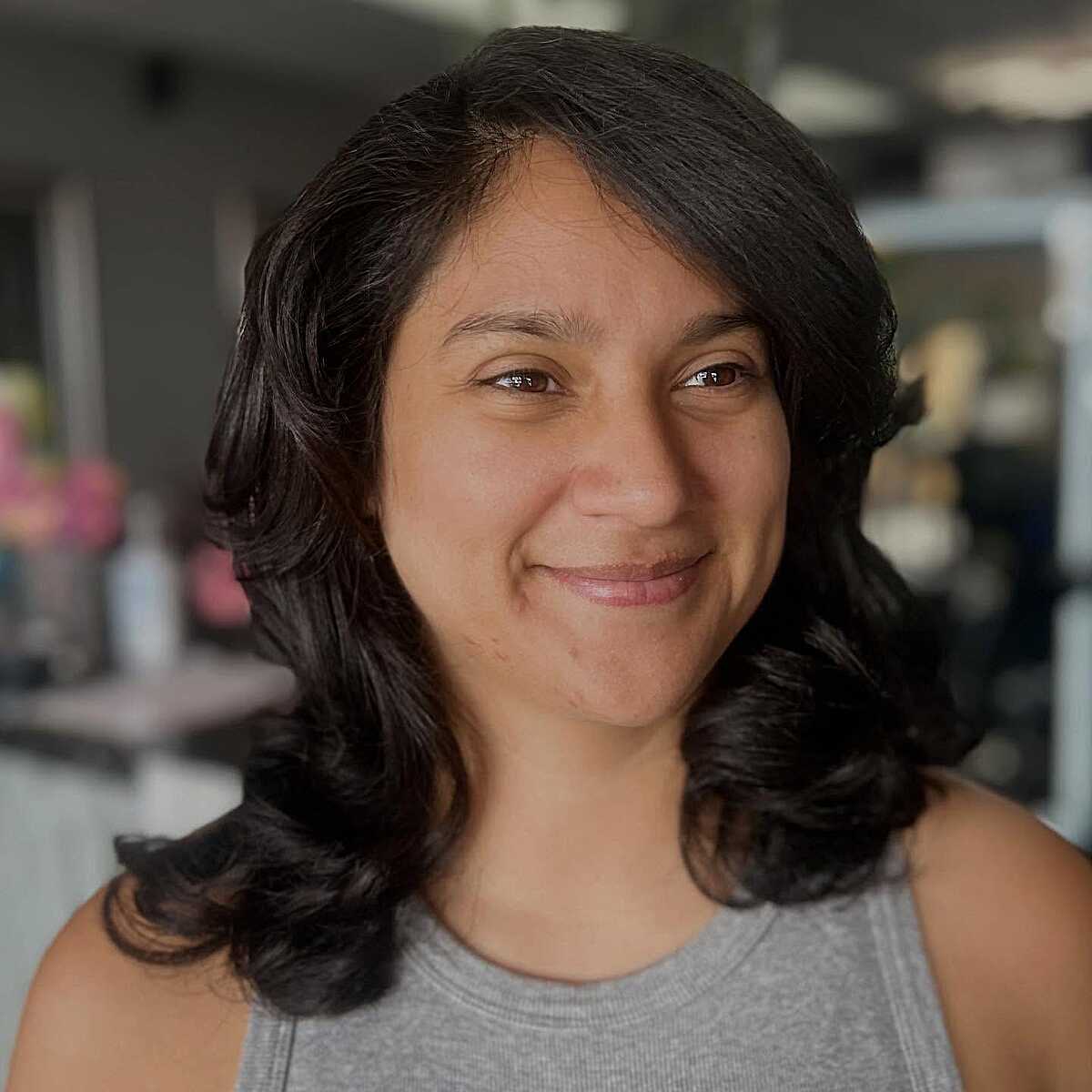 Dark wavy mid-length blowout with center part