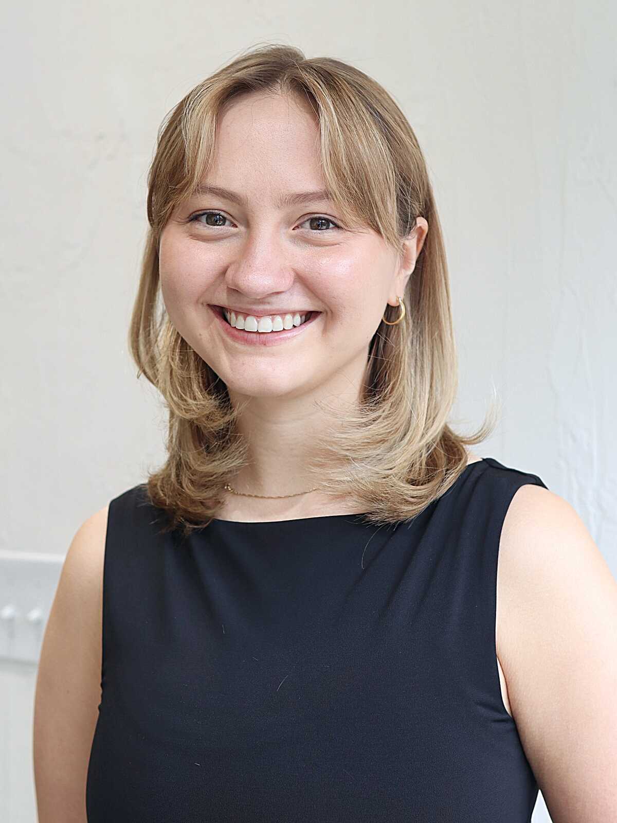 Warm blonde shoulder-length hair with flipped ends